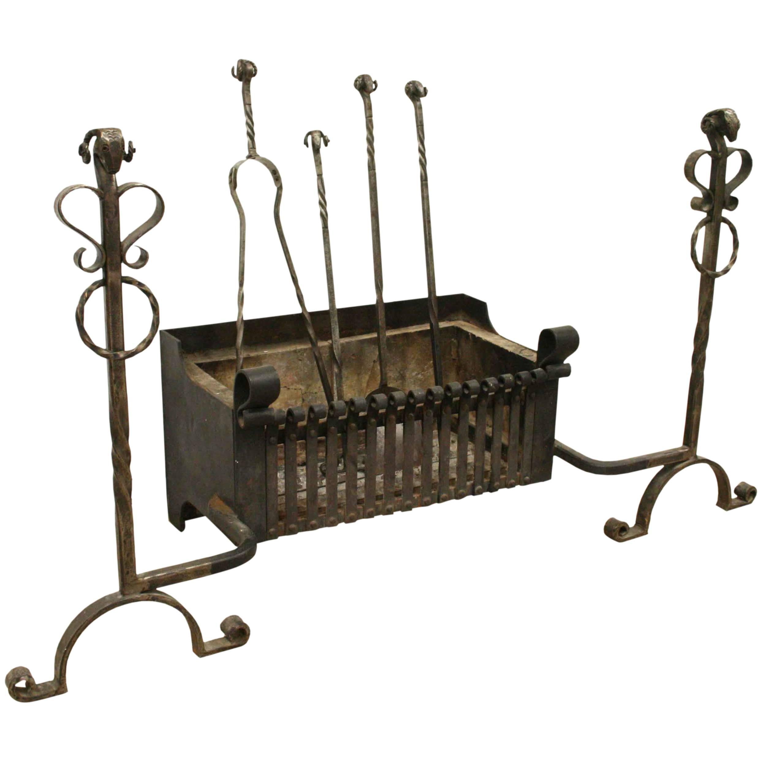 Mid-20th century, unusual handmade 17th century style fire grate with integral fire dogs with twisted decorations and ram's head motifs, and matching set of four fire irons.