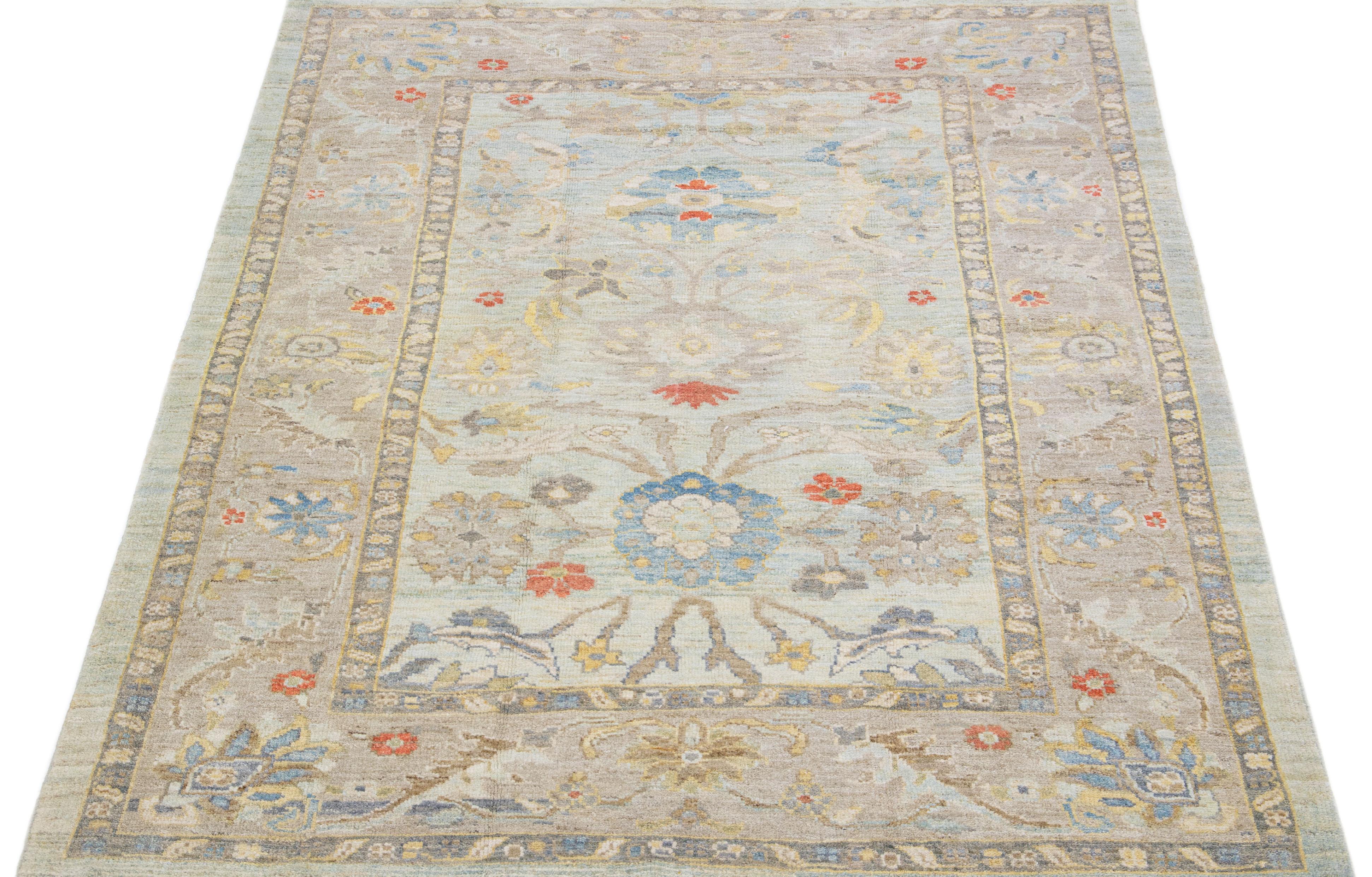 Beautiful modern Sultanabad hand-knotted wool rug with a blue color field. This rug has a designed frame with gray, yellow, and orange accents in a gorgeous all-over floral motif.

This rug measures: 5'10