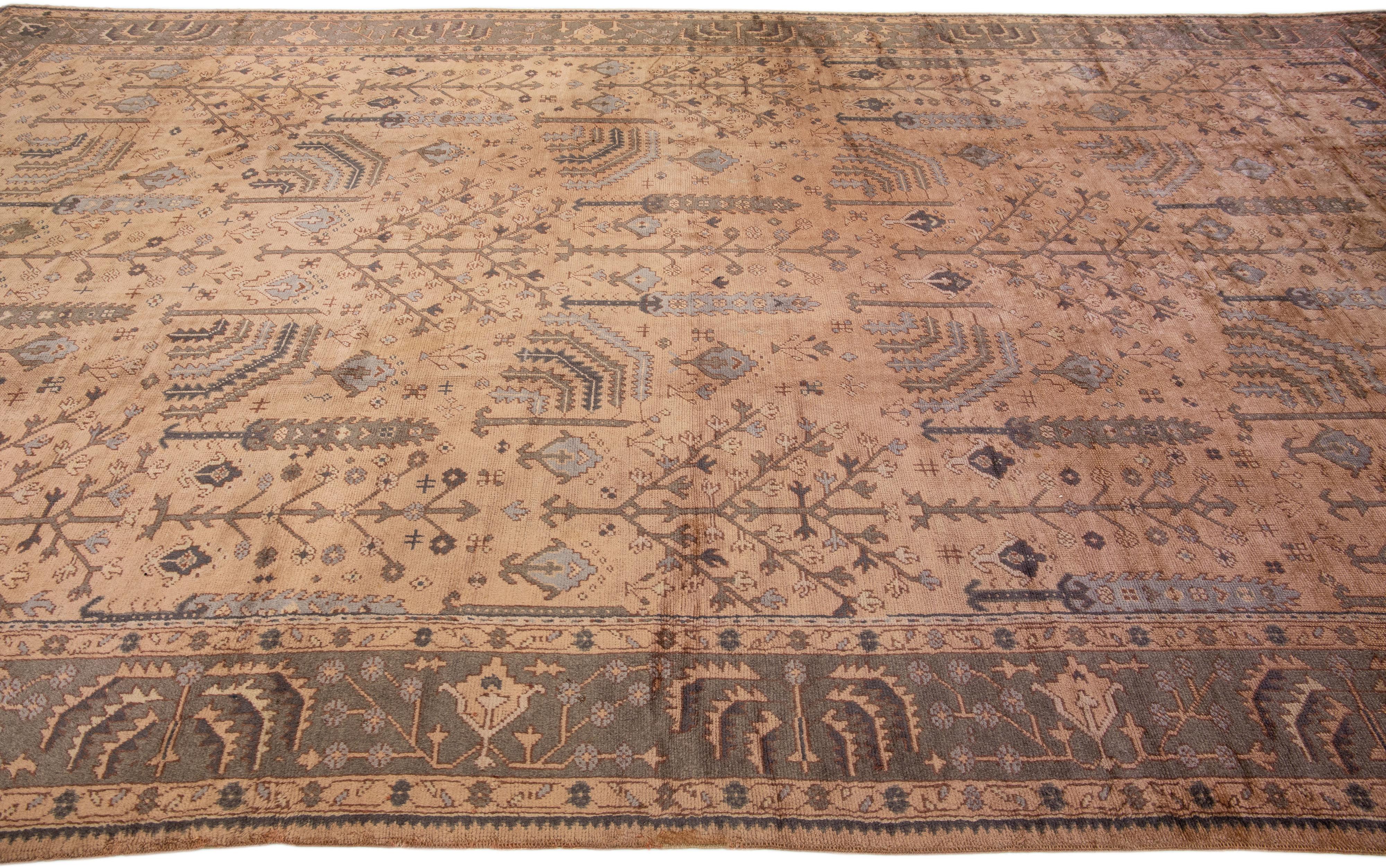 Handmade Floral Antique Turkish Oushak Oversize Wool Rug with Allover Tan Field In Good Condition For Sale In Norwalk, CT