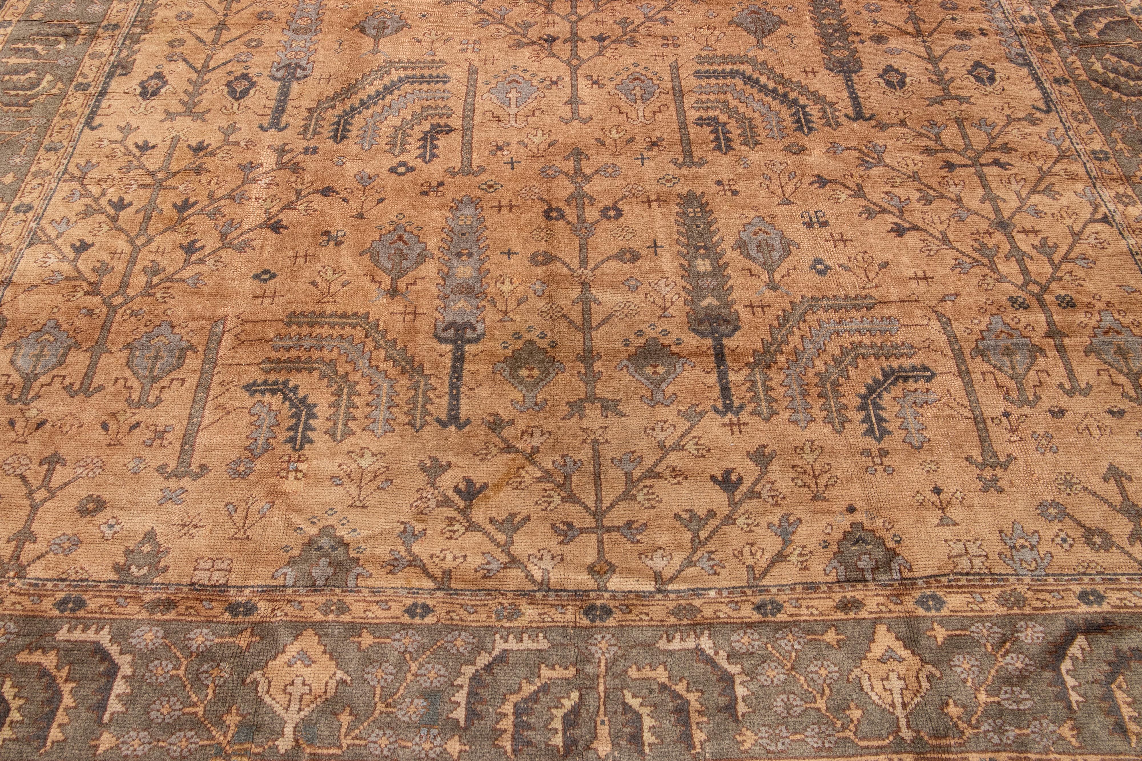20th Century Handmade Floral Antique Turkish Oushak Oversize Wool Rug with Allover Tan Field For Sale