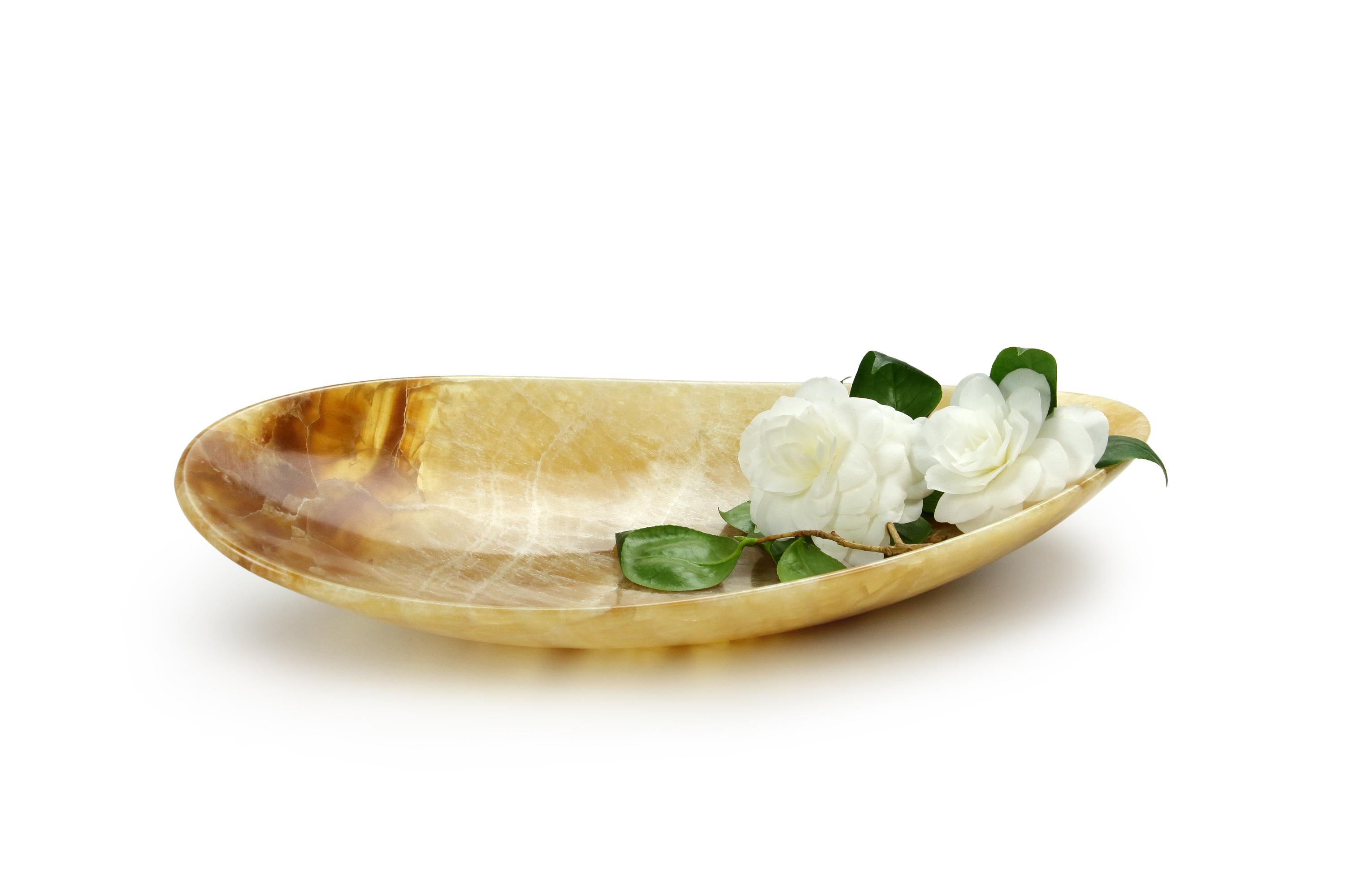 Bowl sculpted by hand from a solid block of Amber onyx. The polished finishing underlines the transparency of the onyx making this a very precious object.

Dimensions: Medium L 45, W 22, H 10 cm. Also available: Big L 56, W 27, H 12 cm, small L 35,