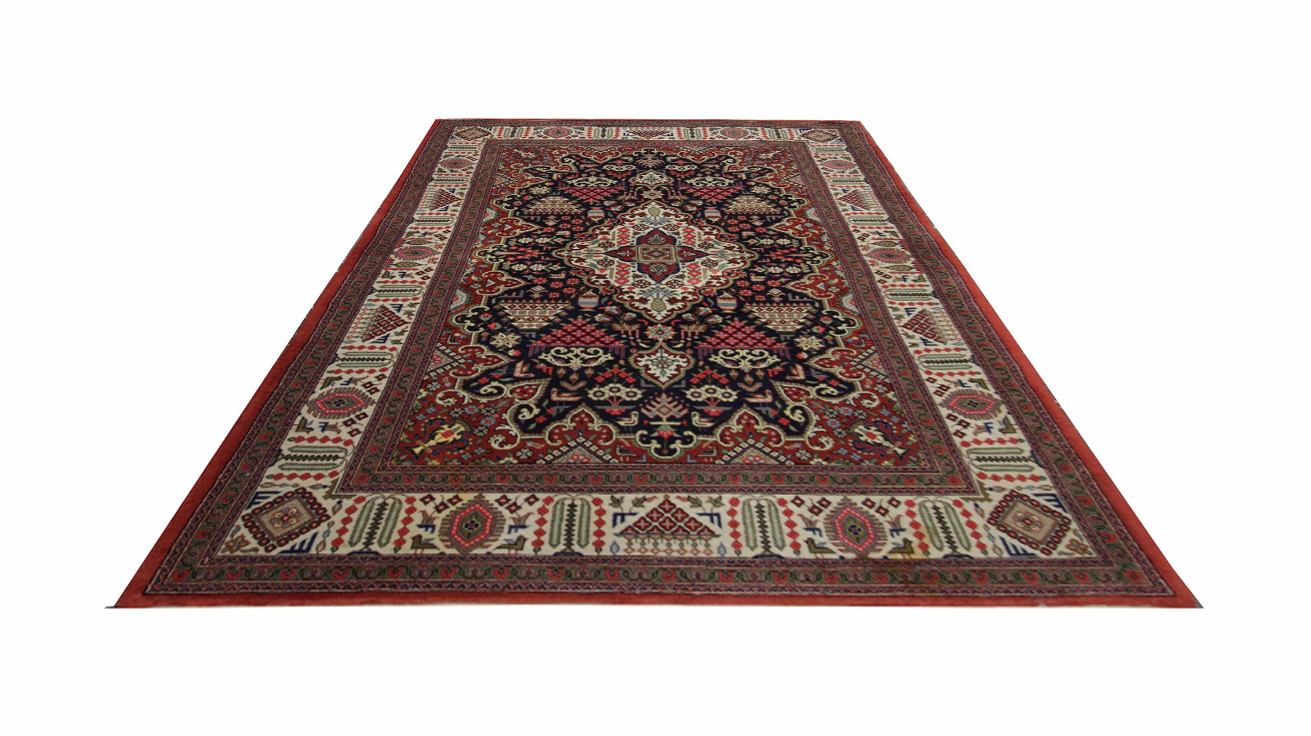 This elegantly woven wool carpet was constructed by hand in the 1995s. The central design has been woven with an elegant central medallion and highly decorative surrounding design. Deep red, brown, green, and blue make up the main colour palette for