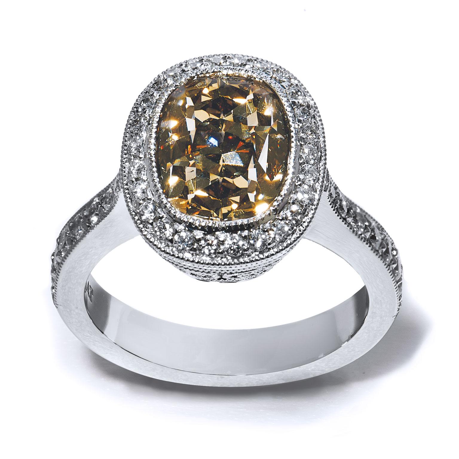 Exquisite Fancy Yellow Brown Diamond Platinum Engagement Ring with a 4.03ct Fancy Yellow Brown Diamond center. Pave set diamonds dance around the stone and down the shank. Exquisitely crafted by hand, this is an elegant piece from the H&H