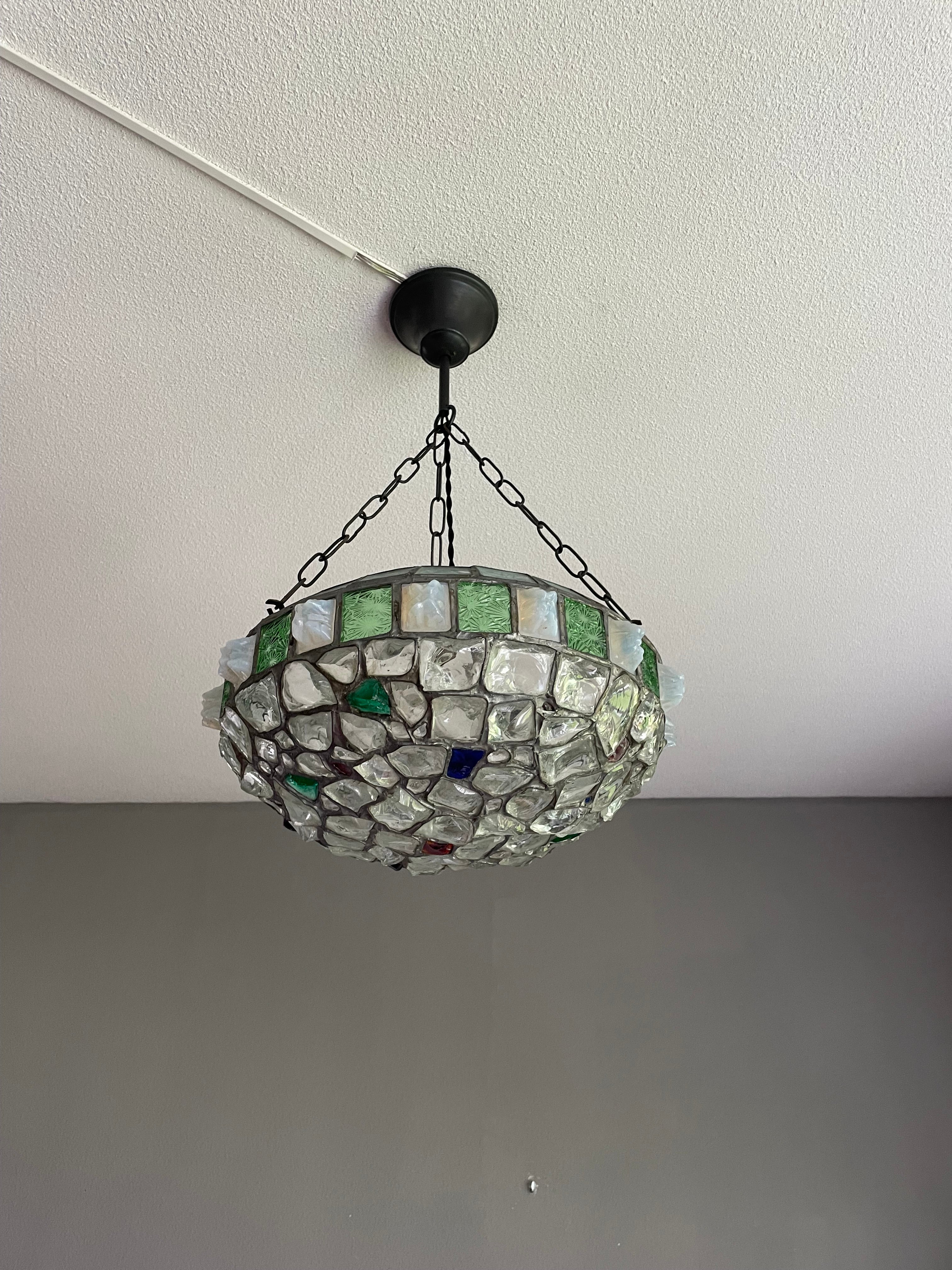 Very cool, inlaid 'chunky glass' light fixture from the early 1900s.

This great looking and intricate workmanship pendant from the earliest years of the 20th century is another one of our recent great finds. With early 20th century lighting being