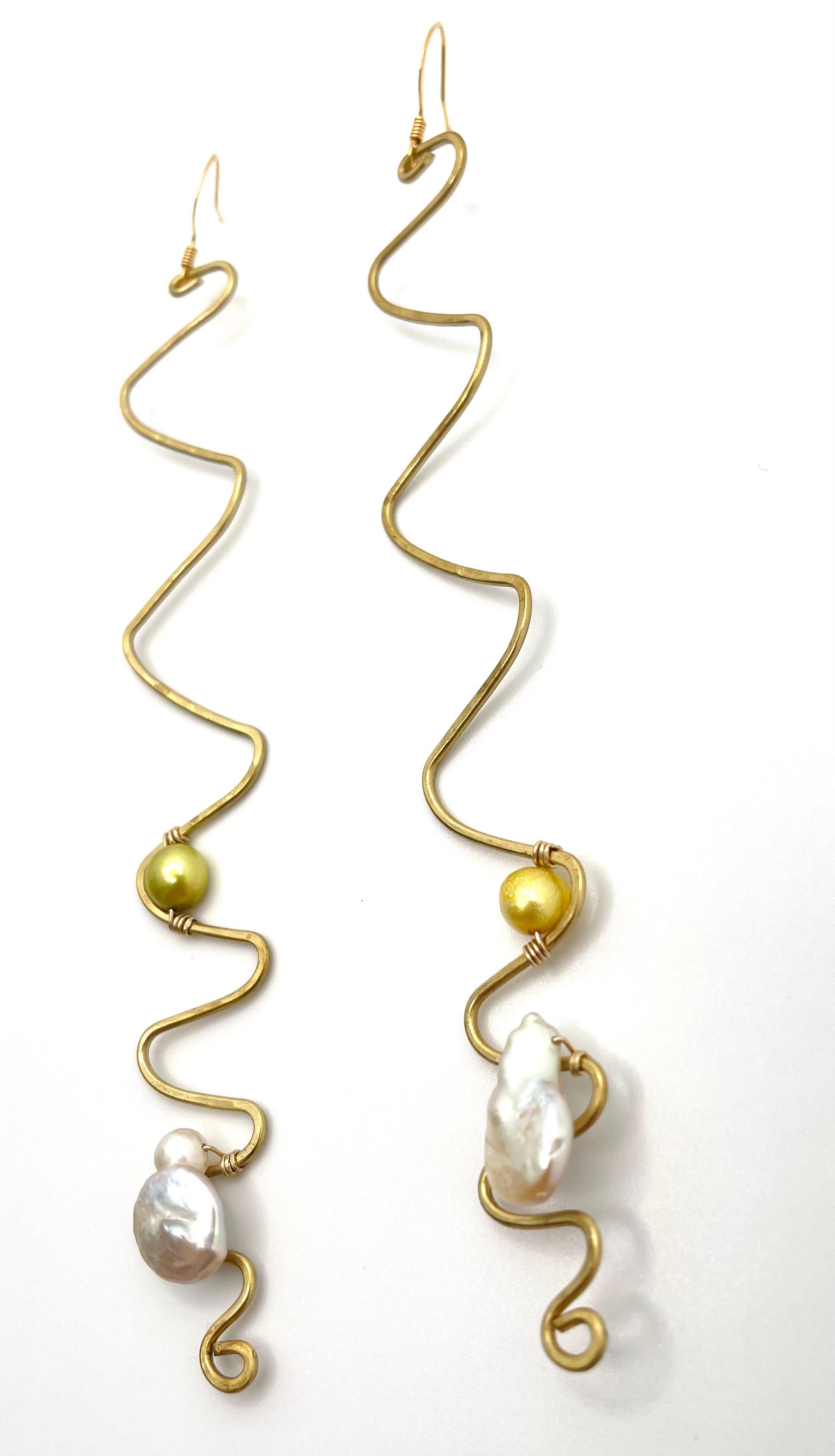 Handmade Freshwater Pearls Wavy Fleur Earrings by Sidney Cherie Studio

Long, zig-zag gold brass cascades to the shoulders in these Wavy Fleur Earrings. The long wave emulates having a cascade of wavy natural hair. The minimalist layout of the green