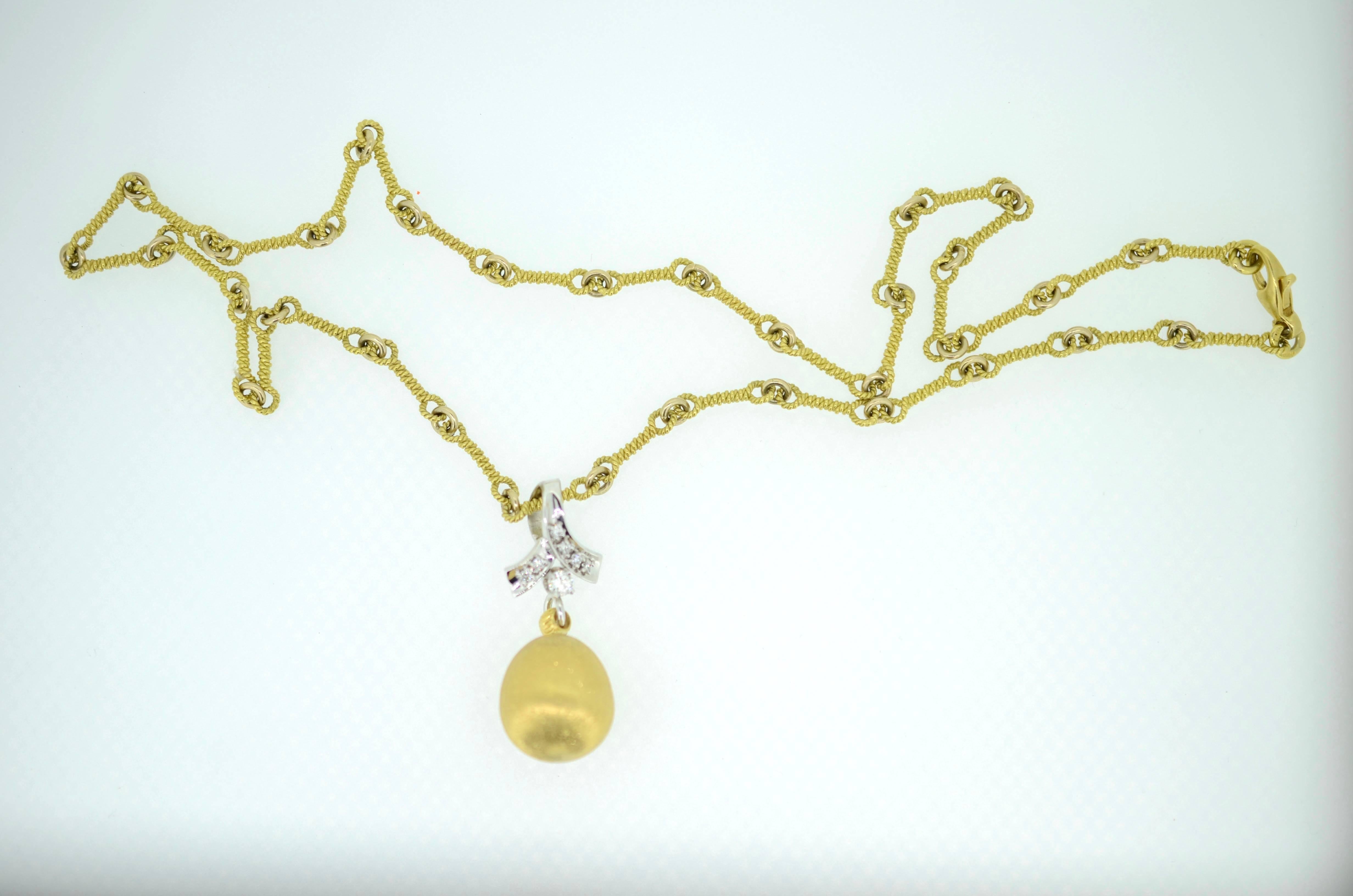 Elegant one of a kind hand made 18kt yellow gold and 14kt white gold and diamond neckpiece. Sphere is hand made 14.8 grams, 18mm in 18kt yellow gold. 
Pendant sphere is 18kt yellow gold, textured full dimension with 14kt white gold ribbon set with