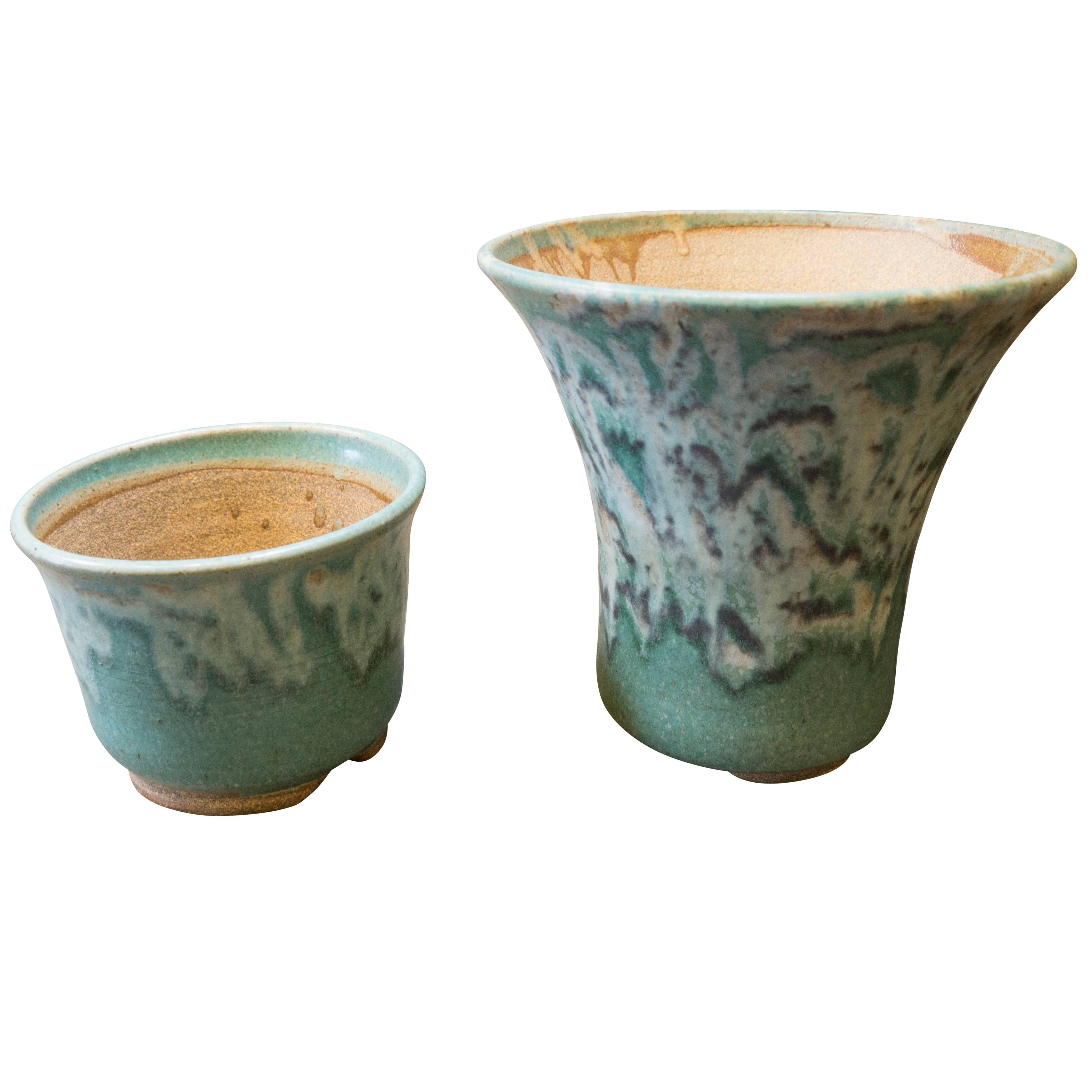 American handmade tabletop vessel featuring exciting green and white glaze design. Available as is, or with a smaller companion piece as shown in the additional images this vase-like vessel is just eight inches tall and the lip tapers out to a