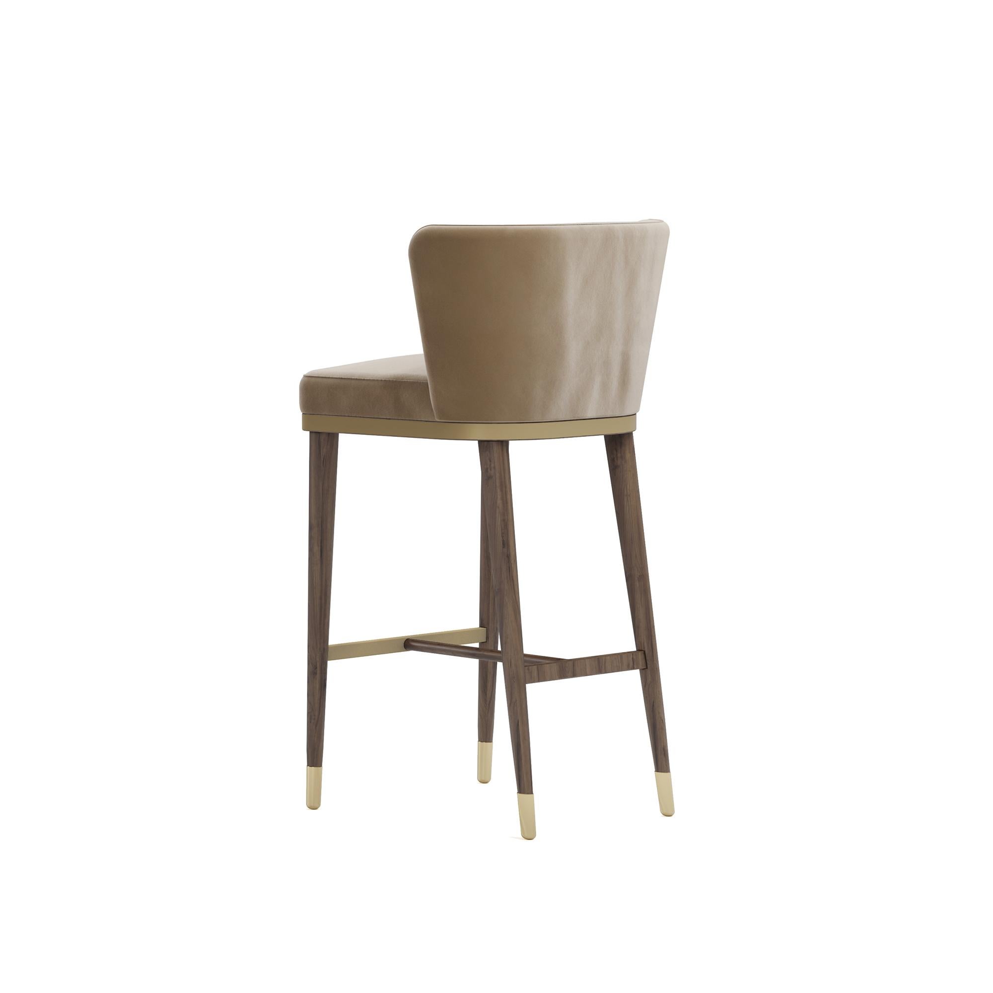 The Hazel Bar Chair by Nolita Harbour is a perfect blend of modern elegance and timeless design, crafted to enhance the ambiance of any bar or kitchen space. This bar chair combines luxurious materials with sleek lines, offering a stylish and