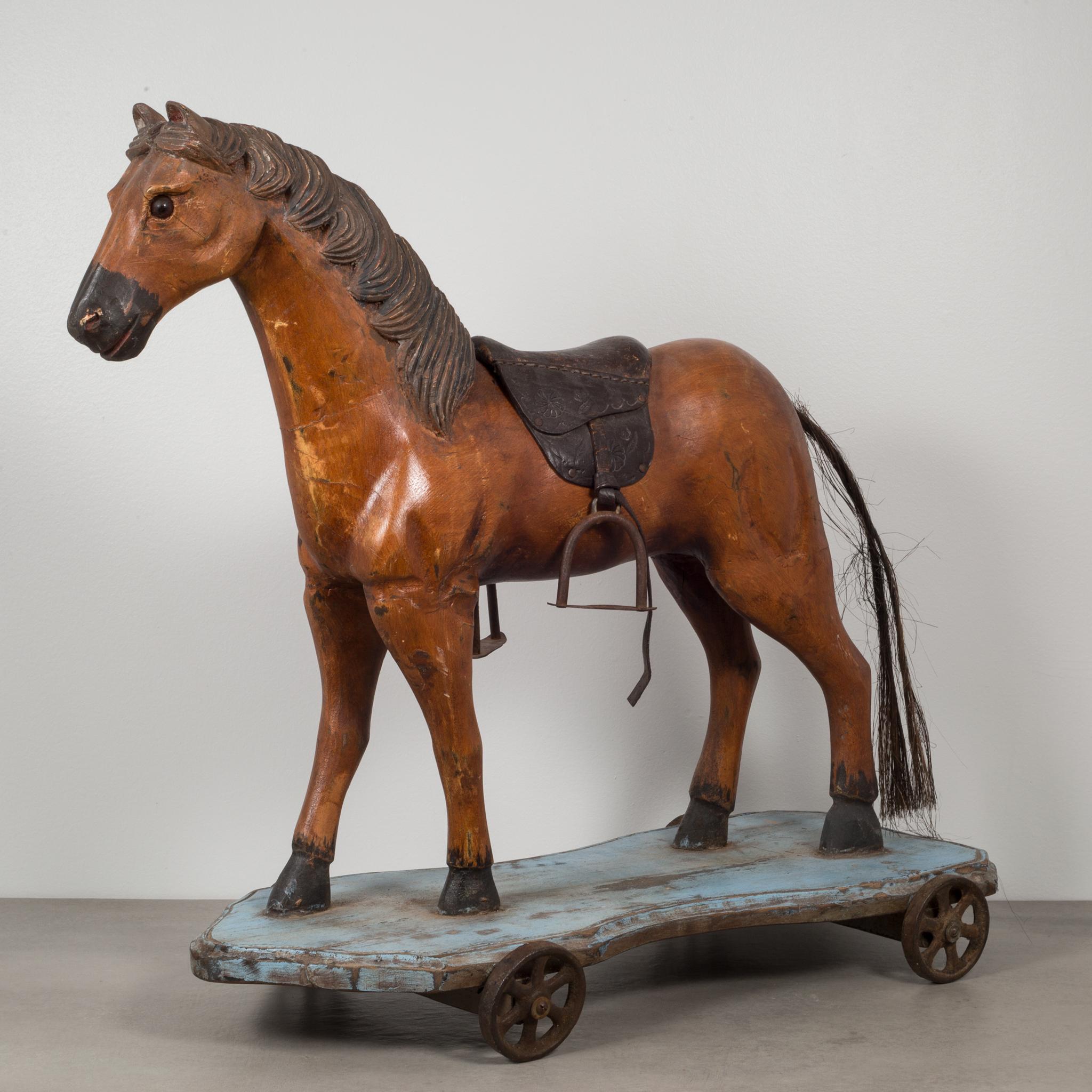 About

This is an original toy horse pull ride. This horse is hand carved wood with detailed mane, glass eyes and a horse hair tail. The saddle is embossed leather with metal stirrups. The horse stands firmly on a wooden plank with steel wheels.