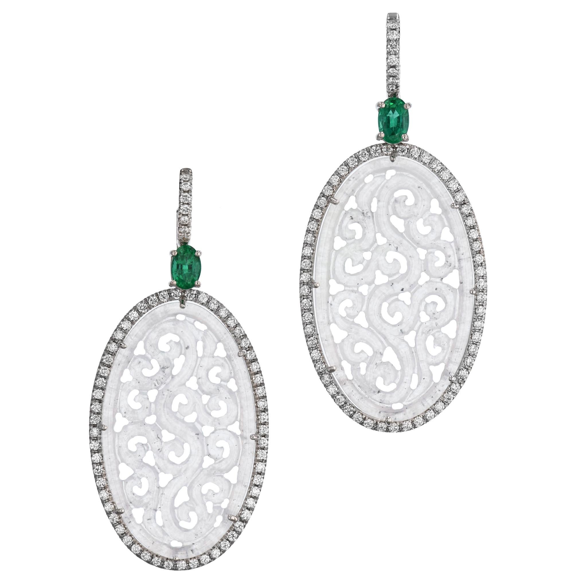 These one of a kind, intricately carved, opulent, and handcrafted Icy Jadeite and Zambian Emerald White Gold Drop Earrings will take your breath away. 
Featuring Burma Icy Jadeite oval stones and radiant Zambian Emeralds prong-set at the top, each