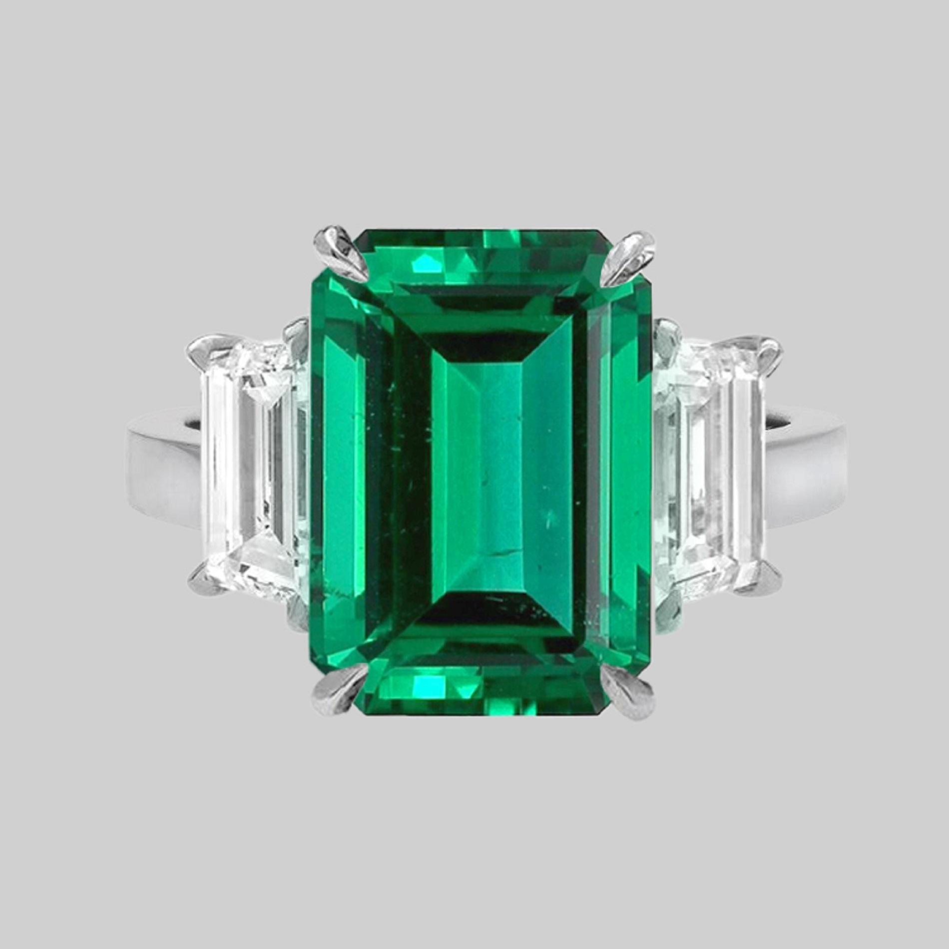 An exquisite 4 carat green emeald with practically no inclusions and a vivid green color!
The side 

EXQUISITE EMERALD AND DIAMOND RING This marvelous 3 stone styled ring sports a Rare  Emerald weighing 4 cts. The real eye catcher of this beautiful