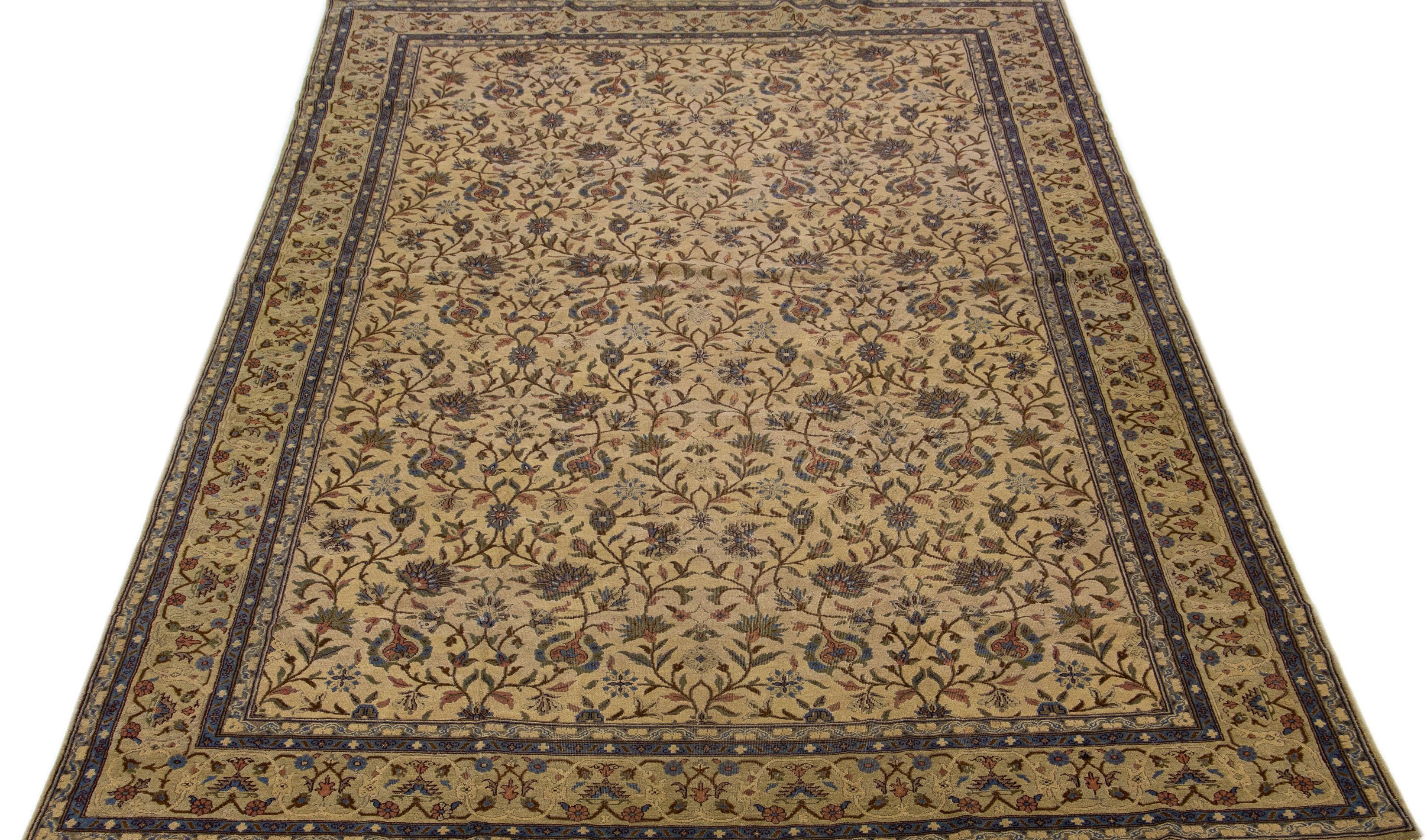 This hand-knotted wool rug boasts a beautiful vintage Turkish design featuring a light brown field color accentuated with stunning green, blue, and pink accents in an elegant all-over floral pattern.

This rug measures 10'7