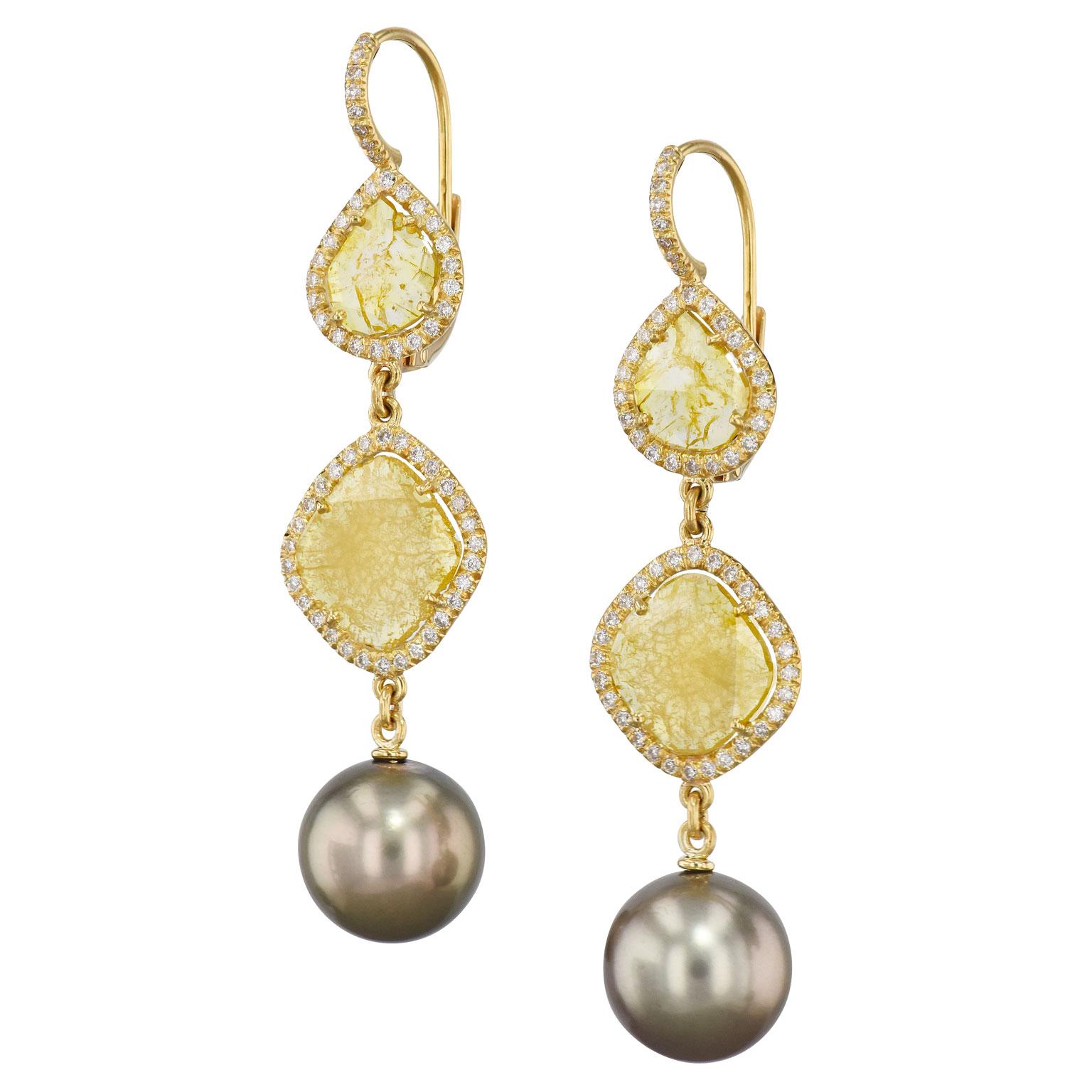 Handmade Intense Yellow Diamond Slice Earrings with Tahitian Pearls

2.49 carats of natural intense yellow diamond slices are surrounded by .59 carats of H/I colors SI1 clarity white diamonds. There are stunning Tahitian Pearls hanging at the bottom
