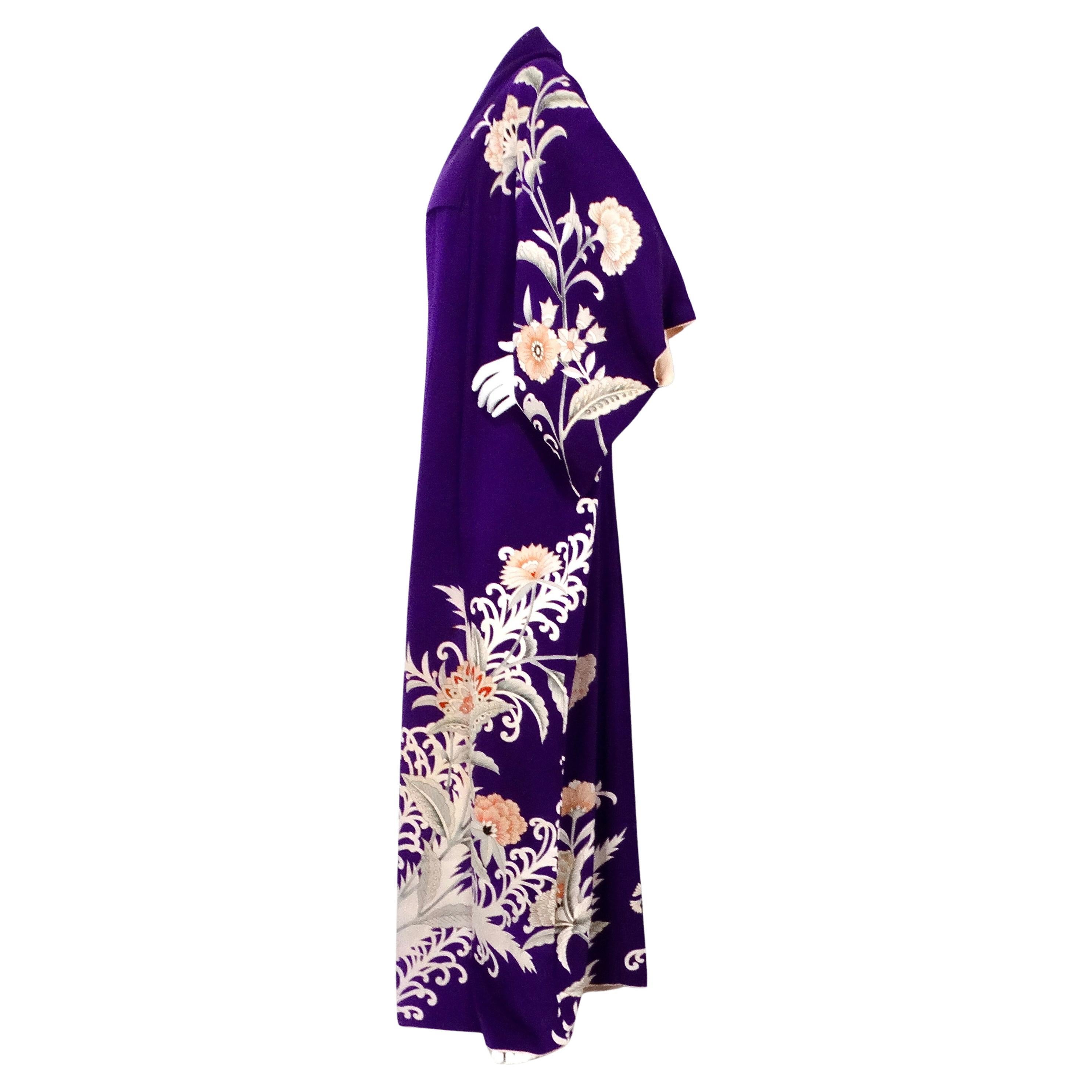 This exquisite Handmade Japanese Purple Floral Print Silk Kimono from the circa 1950s is a stunning example of traditional craftsmanship and timeless elegance. Crafted from luxurious silk, the kimono features a rich purple background adorned with
