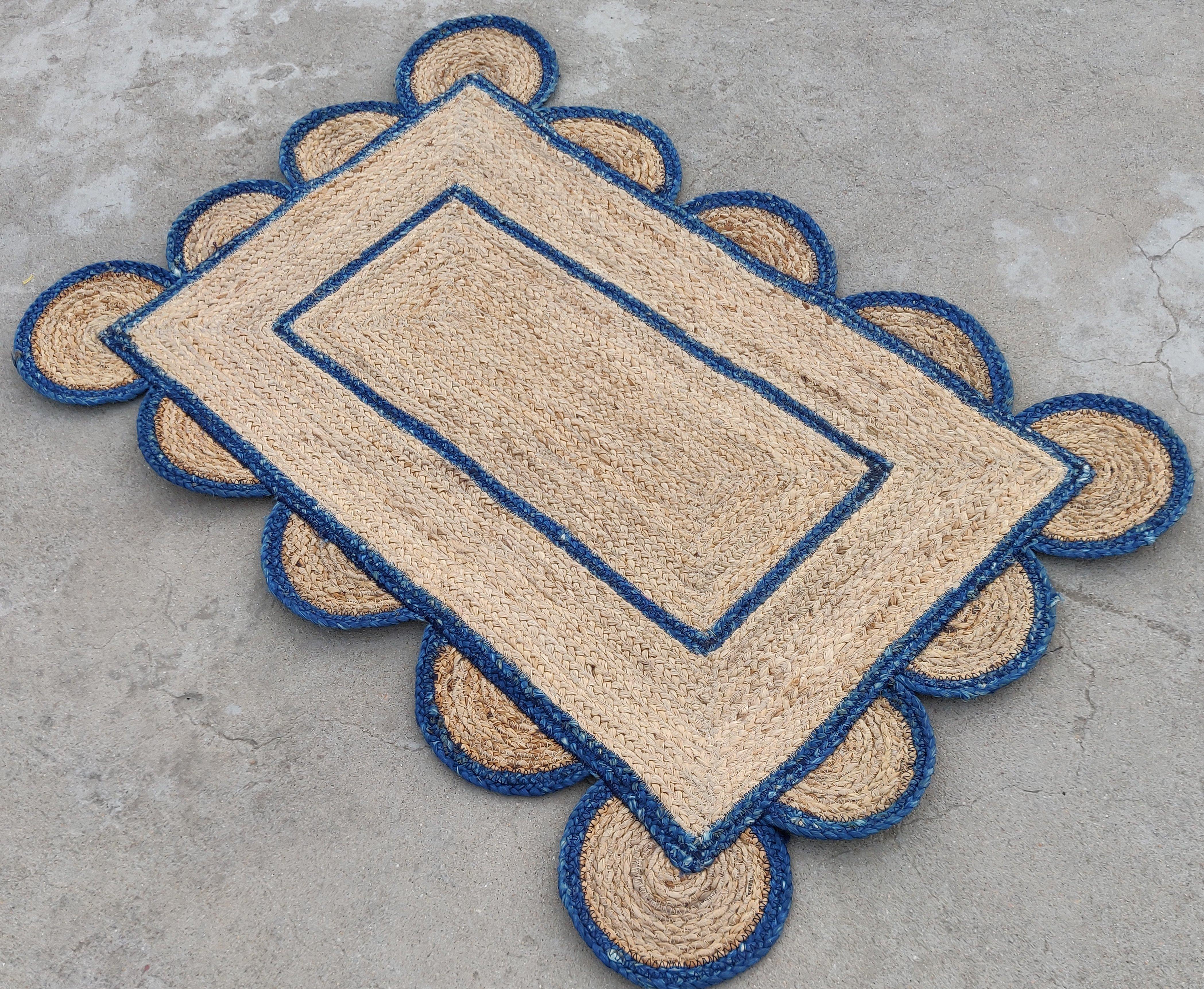 Handmade Jute Scalloped Rug, Natural Jute Dhurrie with Teal Blue Border -2'x3'

These special flat-weave dhurries are hand-woven with 15 ply 100% cotton yarn. Due to the special manufacturing techniques used to create our rugs, the size and color of