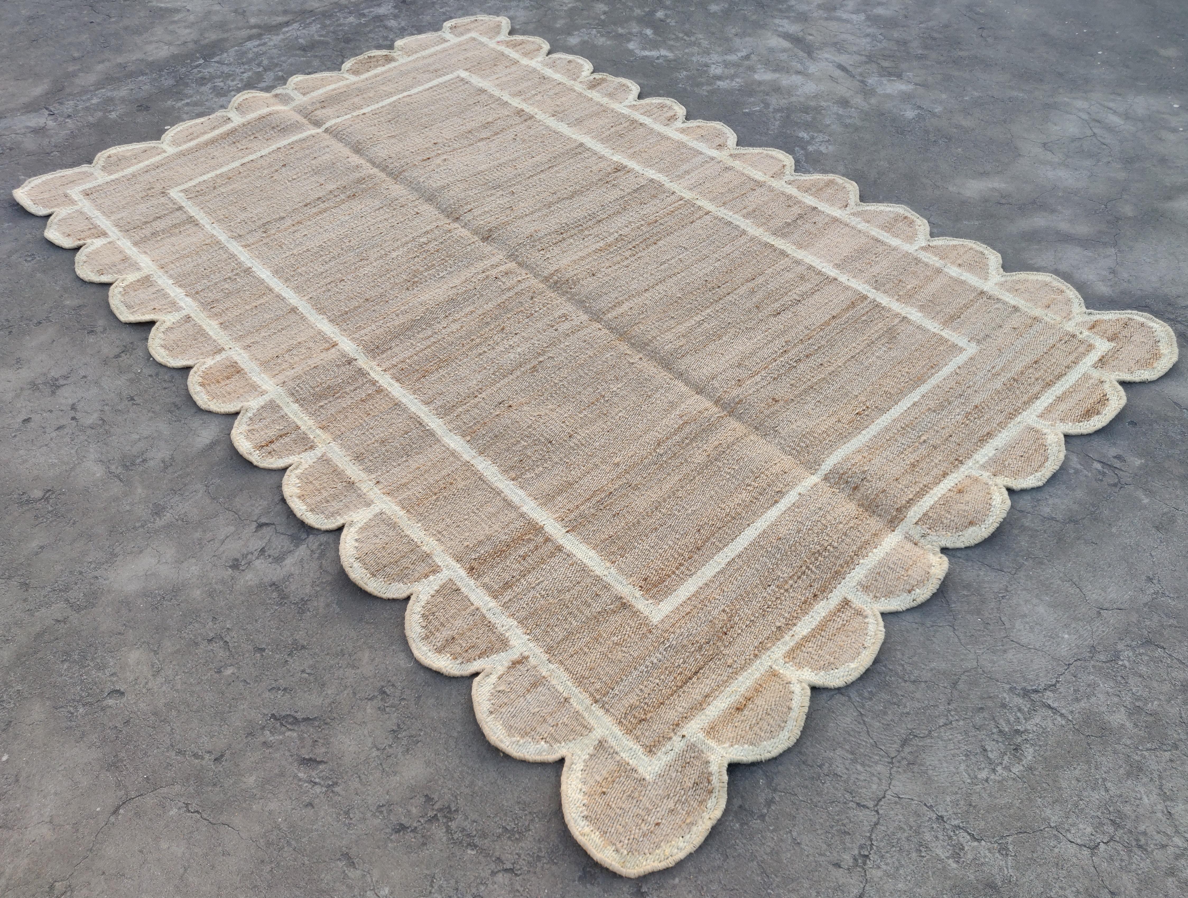 Handmade Jute Scalloped Rug, Natural Jute And Antiqued White Bordered Indian Dhurrie -4'x6'

These special flat-weave dhurries are hand-woven with 15 ply 100% cotton yarn. Due to the special manufacturing techniques used to create our rugs, the size