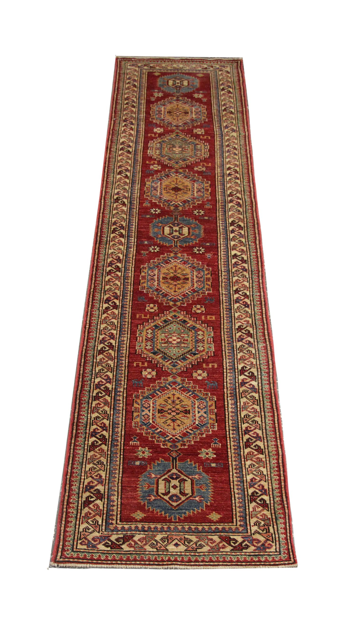 Questo tappeto New Traditional Kazak Runner è un capolavoro splendidamente annodato a mano, realizzato con precisione utilizzando lana e cotone di prima qualità. I suoi sorprendenti motivi geometrici, il design a medaglione centrale e i ricchi