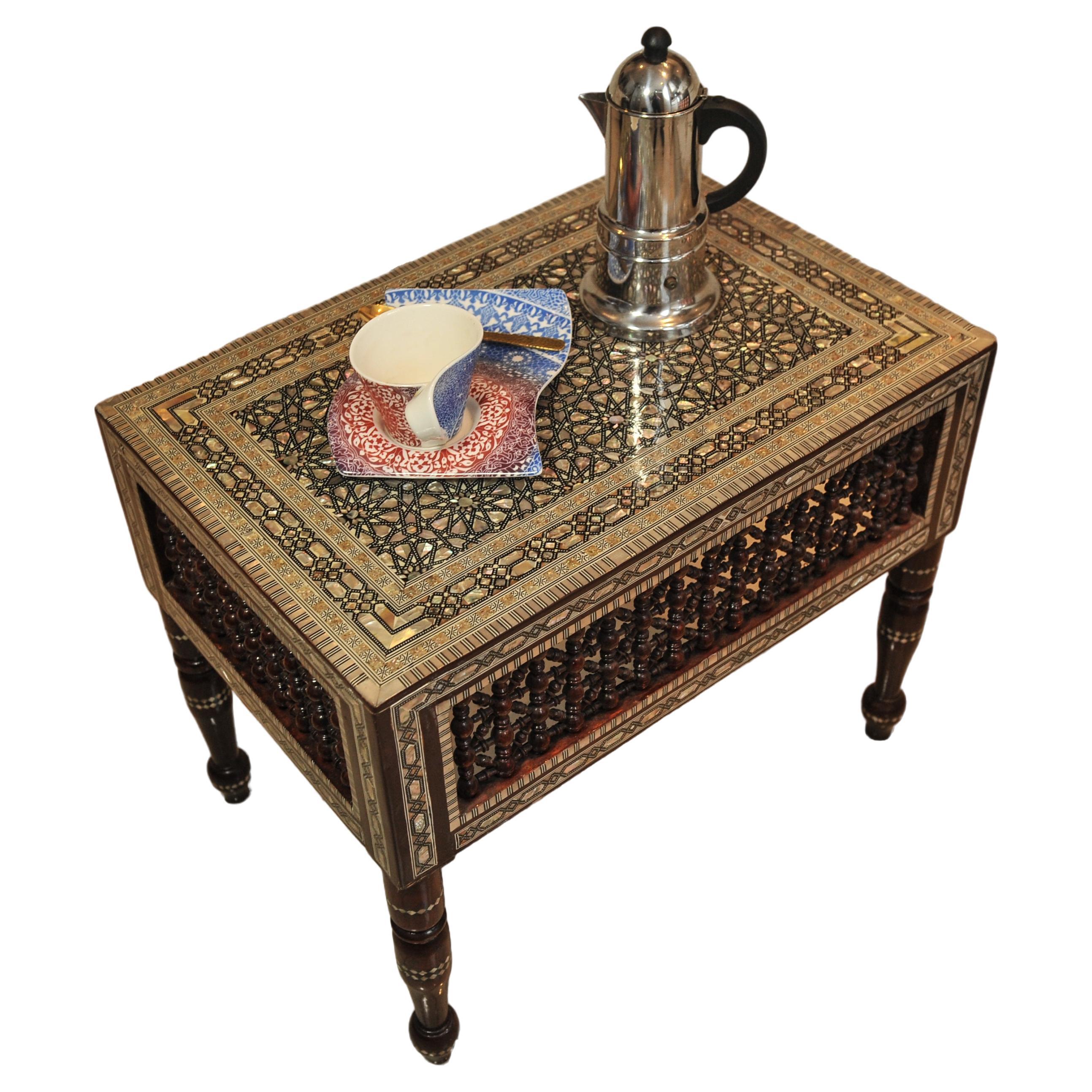 Damascene Moorish Decorative Inlay Tea Table With Matching Wall Mirror 
Featuring A Repetitive Khatam Marquetry of Geometric Decorative Patterns 1910's

Mirror
Height 85.5cm
Width 56.5cm
Depth 3cm 

Table
Height 51cm
Width 61cm
Depth 45.5cm
