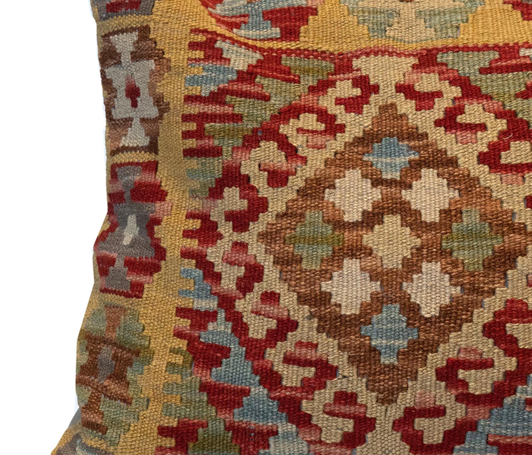 This fantastic cushion has been woven by hand using traditional kilim weaving techniques with hand-spun wool. They featured asymmetrical geometric patterns woven in beautiful rustic colours, including olive green, beige, blue and rust red. These