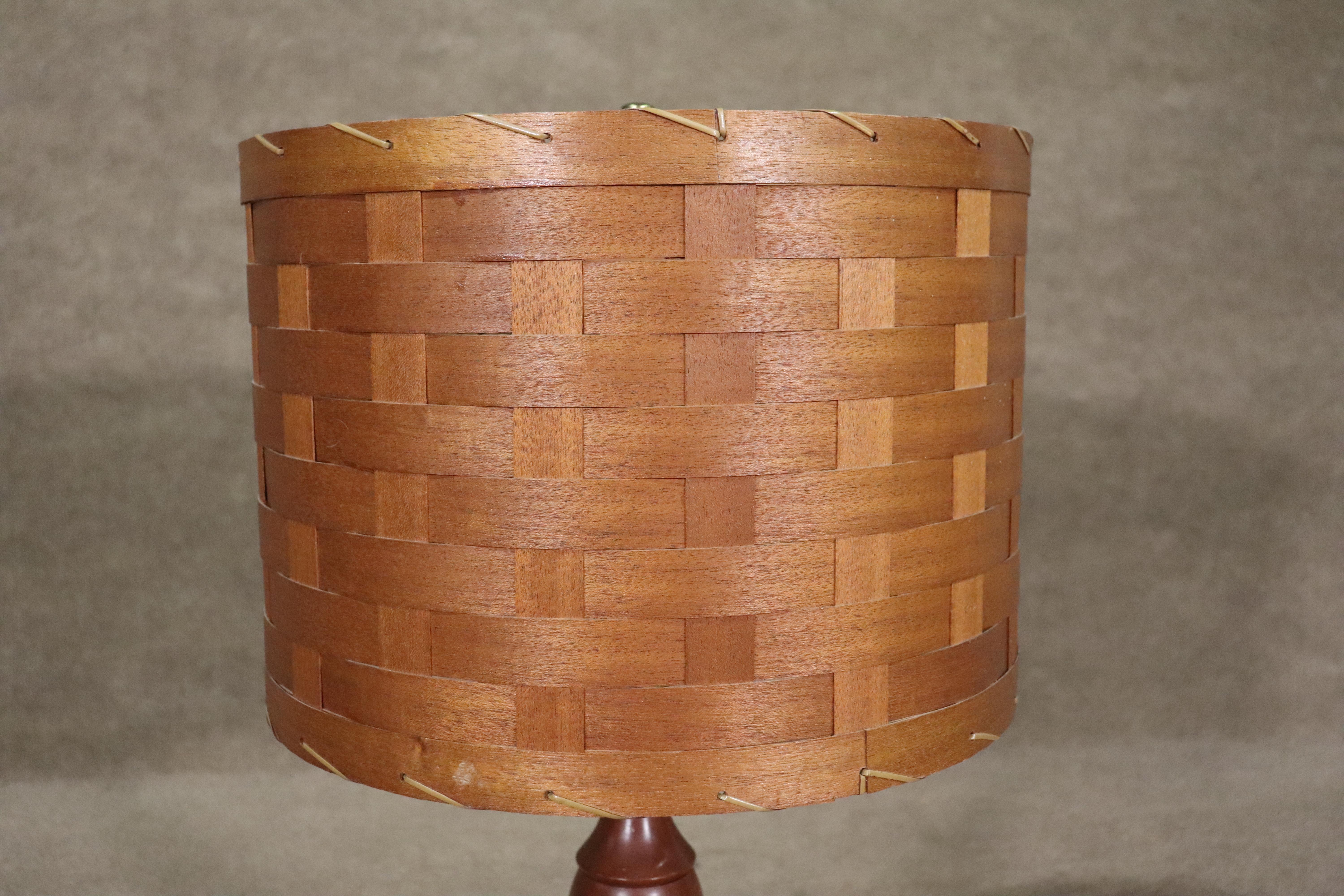 This single vintage table lamp is made in Tennessee by the Wood Whittler Company. Great mid-century style with original woven wood shade. 
Please confirm location NY or NJ
