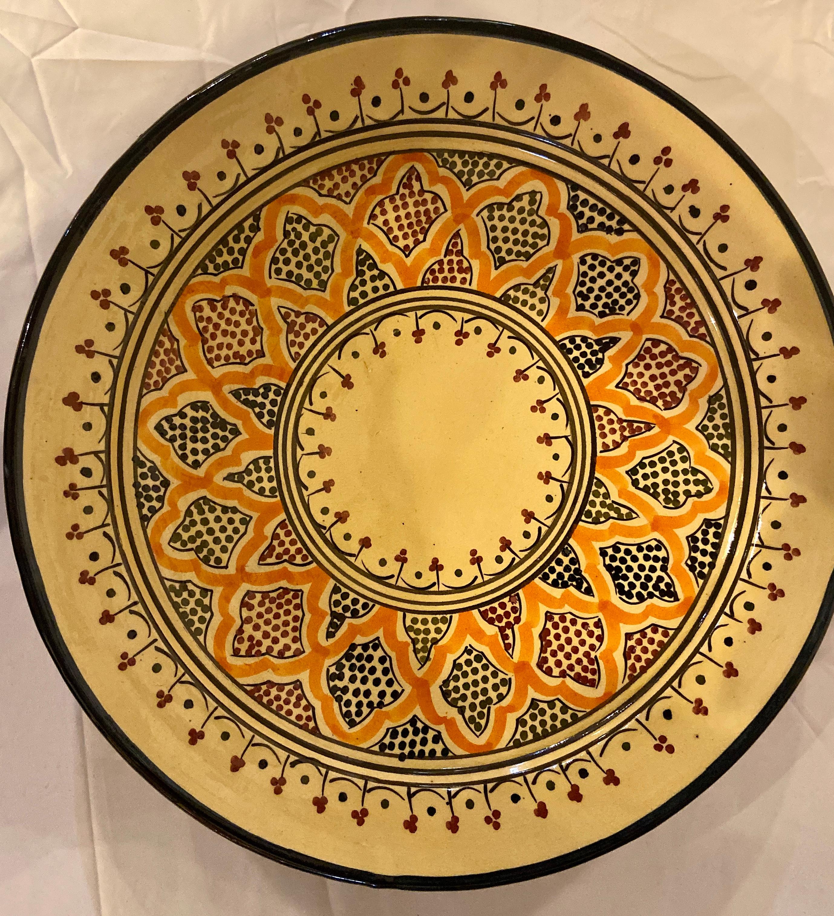 With a delightful floral and arabesque design hand painted in multiple colors in blue, yellow, green and orange. These gorgeous, large-size ceramic dinner plates possess a truly exotic look. Handcrafted in the bustling workshops of master artisans