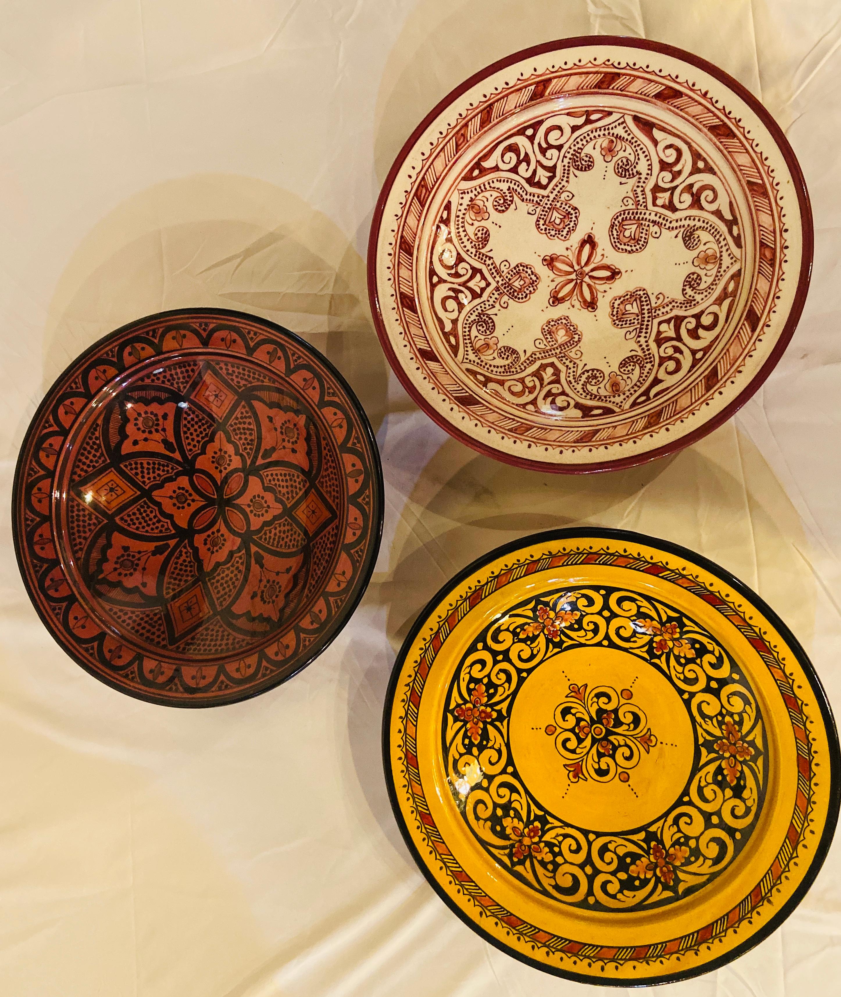 With a delightful floral and arabesque design hand painted in multiple colors in red, yellow, green, and black. These gorgeous, large-size ceramic dinner plates possess a truly exotic look. Handcrafted in the bustling workshops of master artisans in