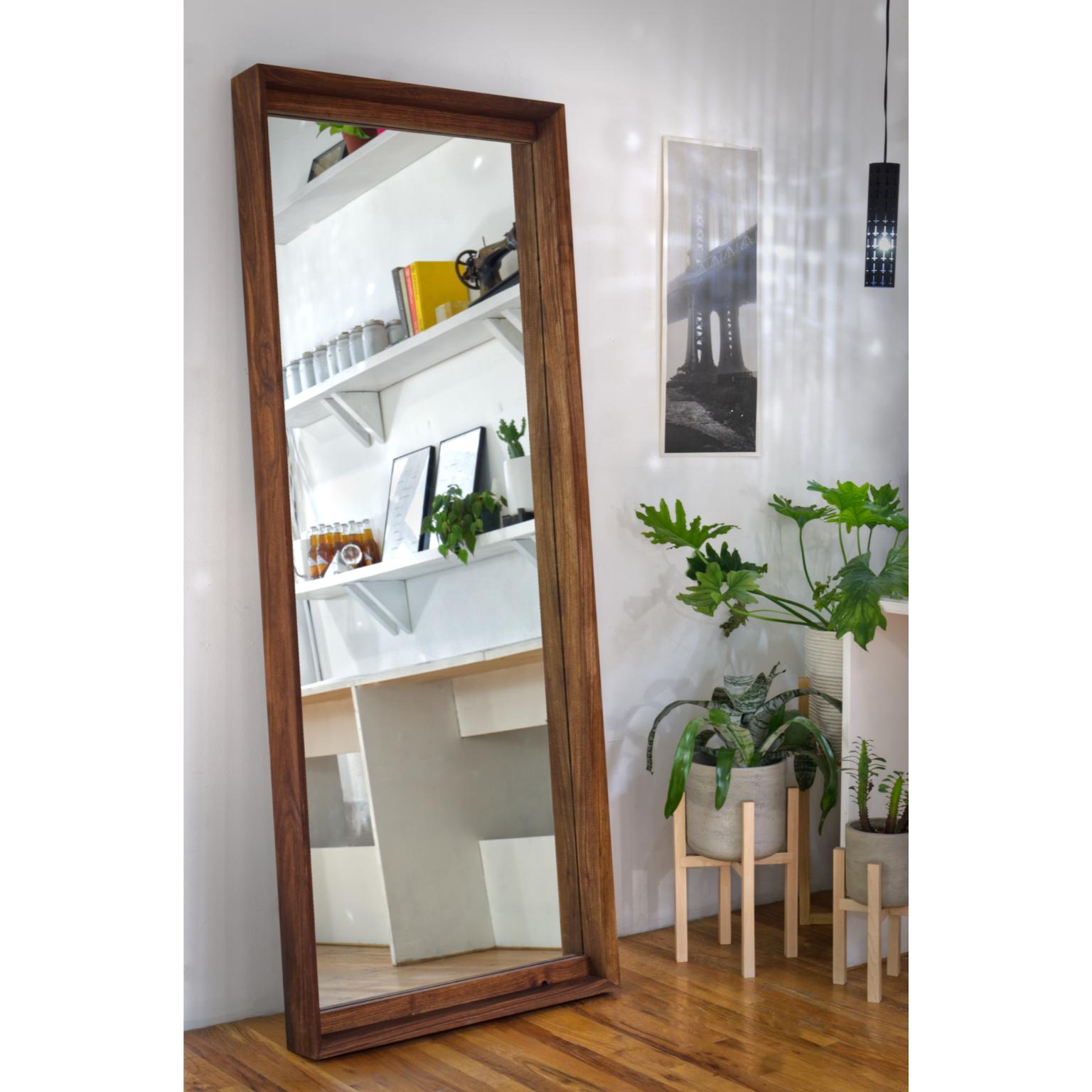 Constructed from solid American walnut the mirror is a portal to another universe. Standing at 6’+ tall it doubles space and stands at your favorite wall for the creation of the days outfit. The the frame is 1