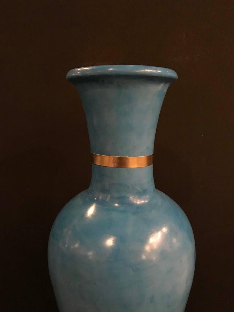 A large Moroccan hand painted blue vase. Brighten your surroundings with this magnificently handcrafted ceramic vase. Featuring a vivid turquoise color, this vase will add a touch of exotic sophistication to any living space.