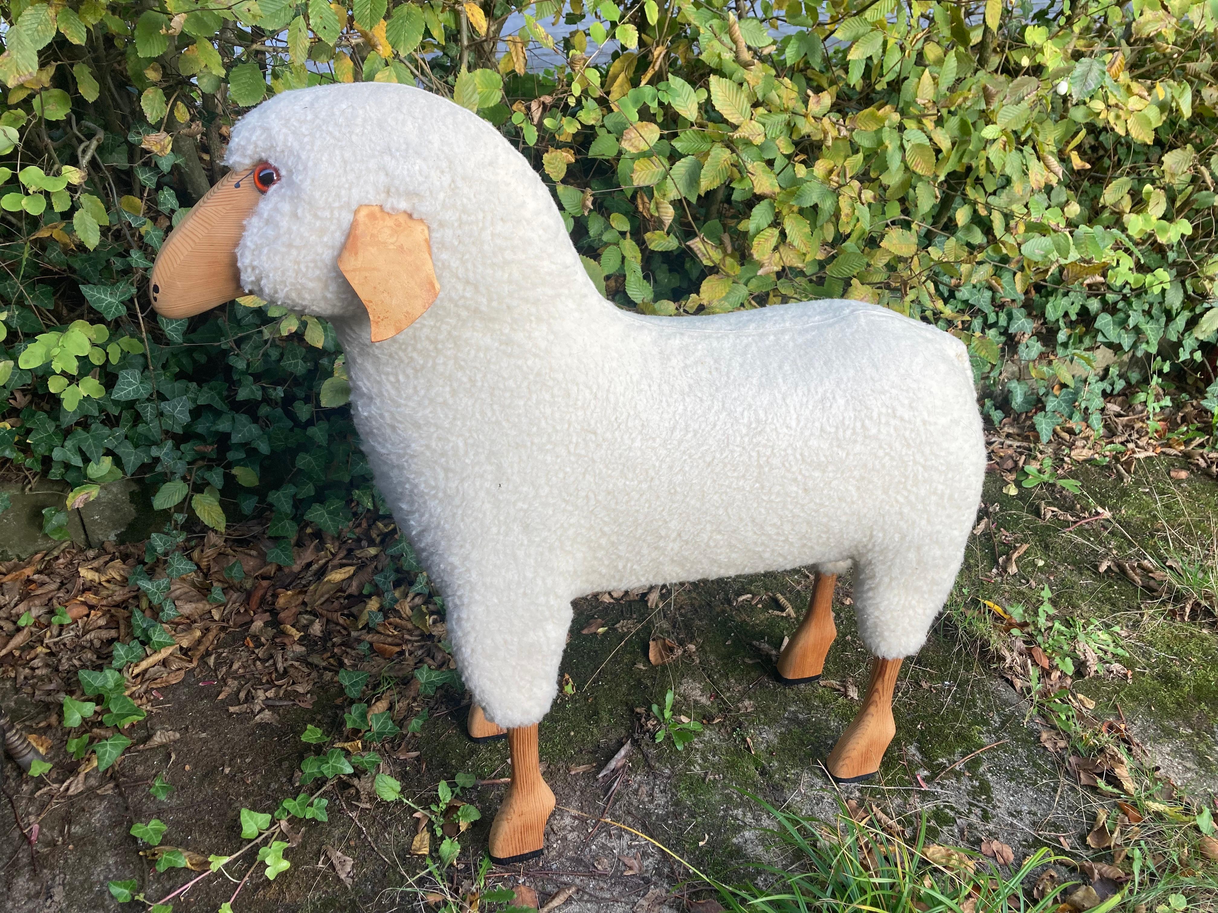A large life -size white wool sheep by Hans-Peter Krafft. 1970s. Made in Germany. 
The sheep was handmade from original white wool, leather and solid high-quality beech wood. The entire production took place in Germany circa 1970.
The sheep