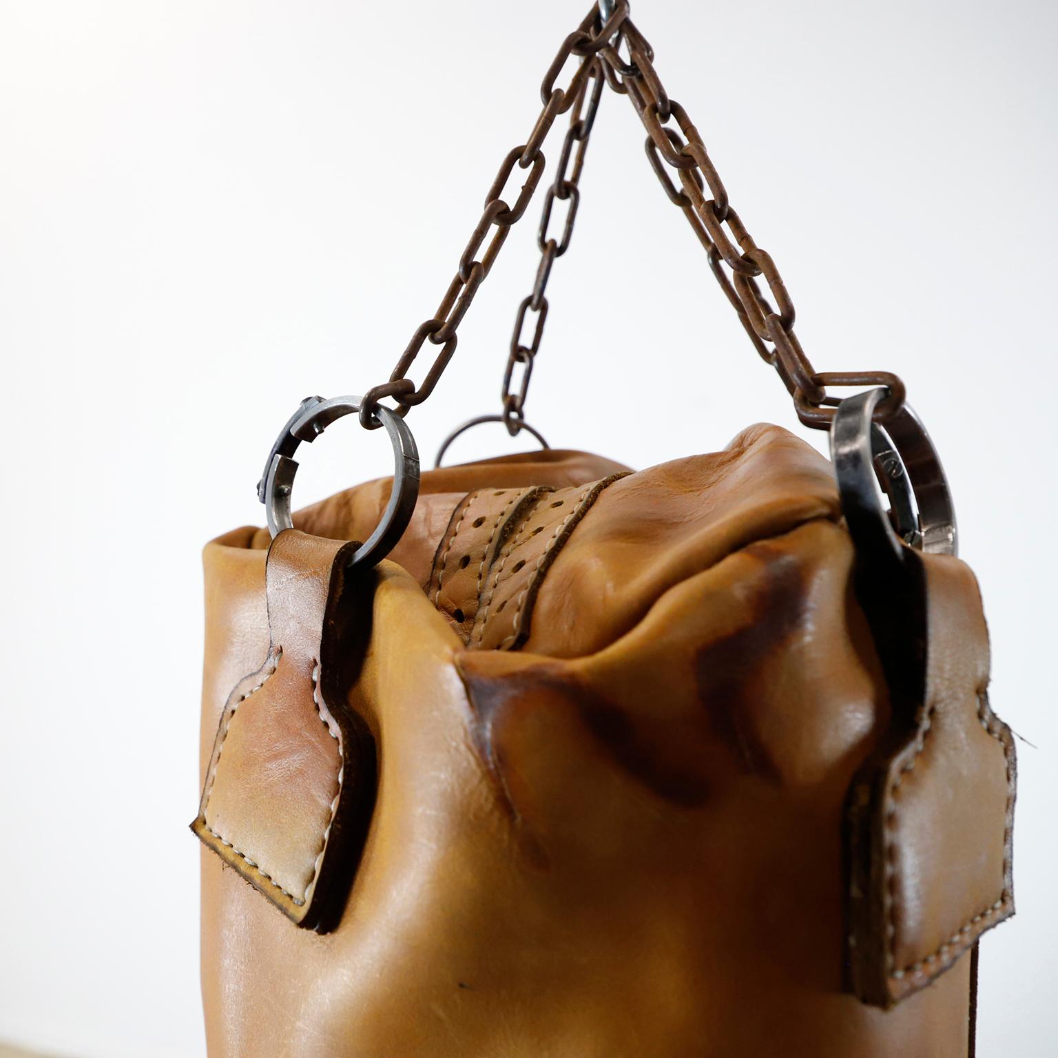 We offer this Leather Gym Punching Boxing Heavy Bag. This piece is made of vintage leather and vintage chains following the design of the ancients punching bags. Includes chains but we not include the material inside the bag.
