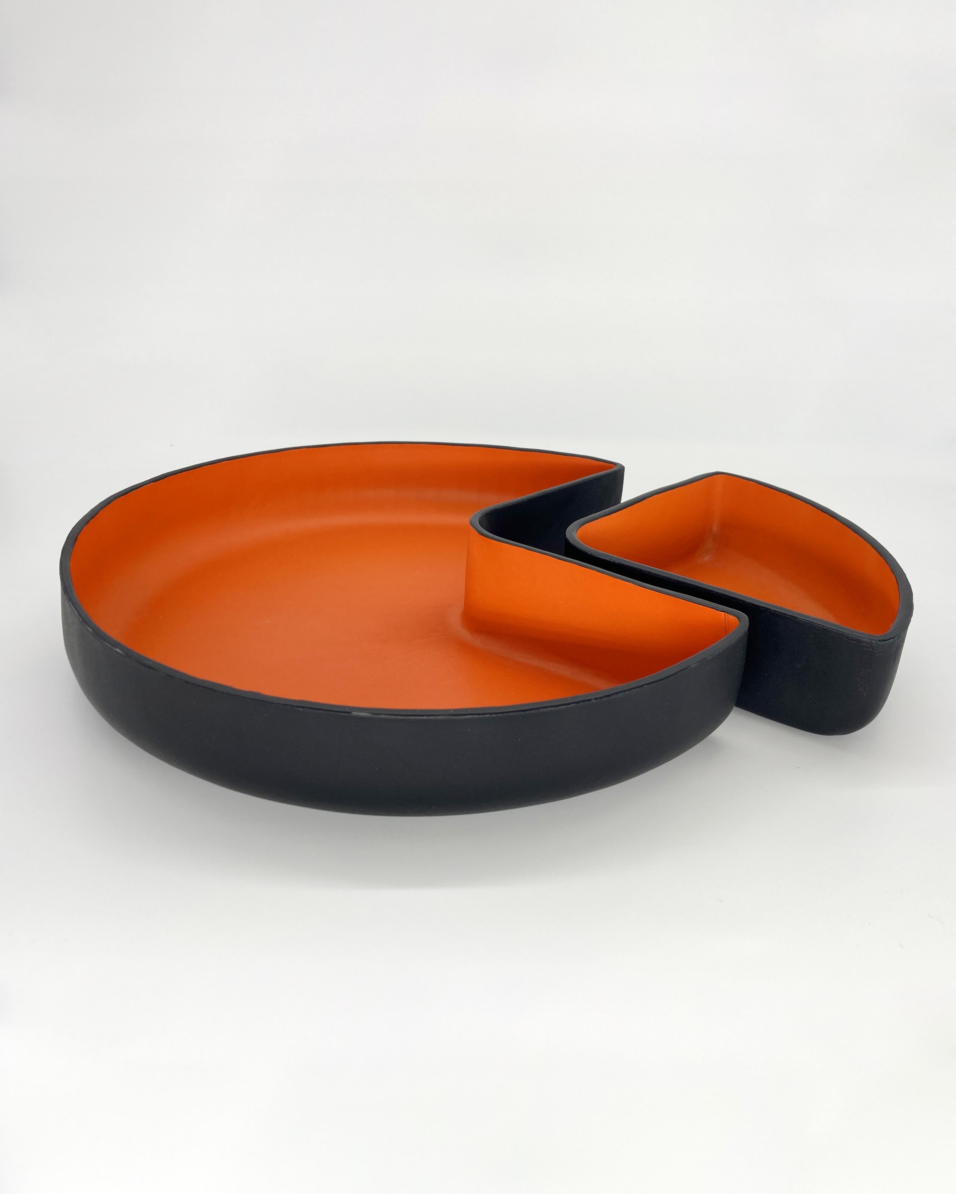 This set of handmade leather bowls in black and orange are the perfect addition to complete your dining room table or as a centerpiece in your living room. Rustic charm meets contemporary handcrafted design sensibility in this exquisite tray set.