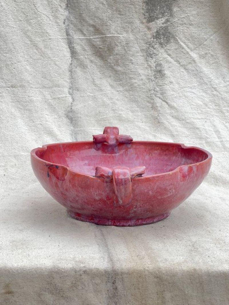 Exquisite magenta ceramic bowl with gracefully curved handles. A striking blend of form and function.  Measurements: 4” h x 14” w