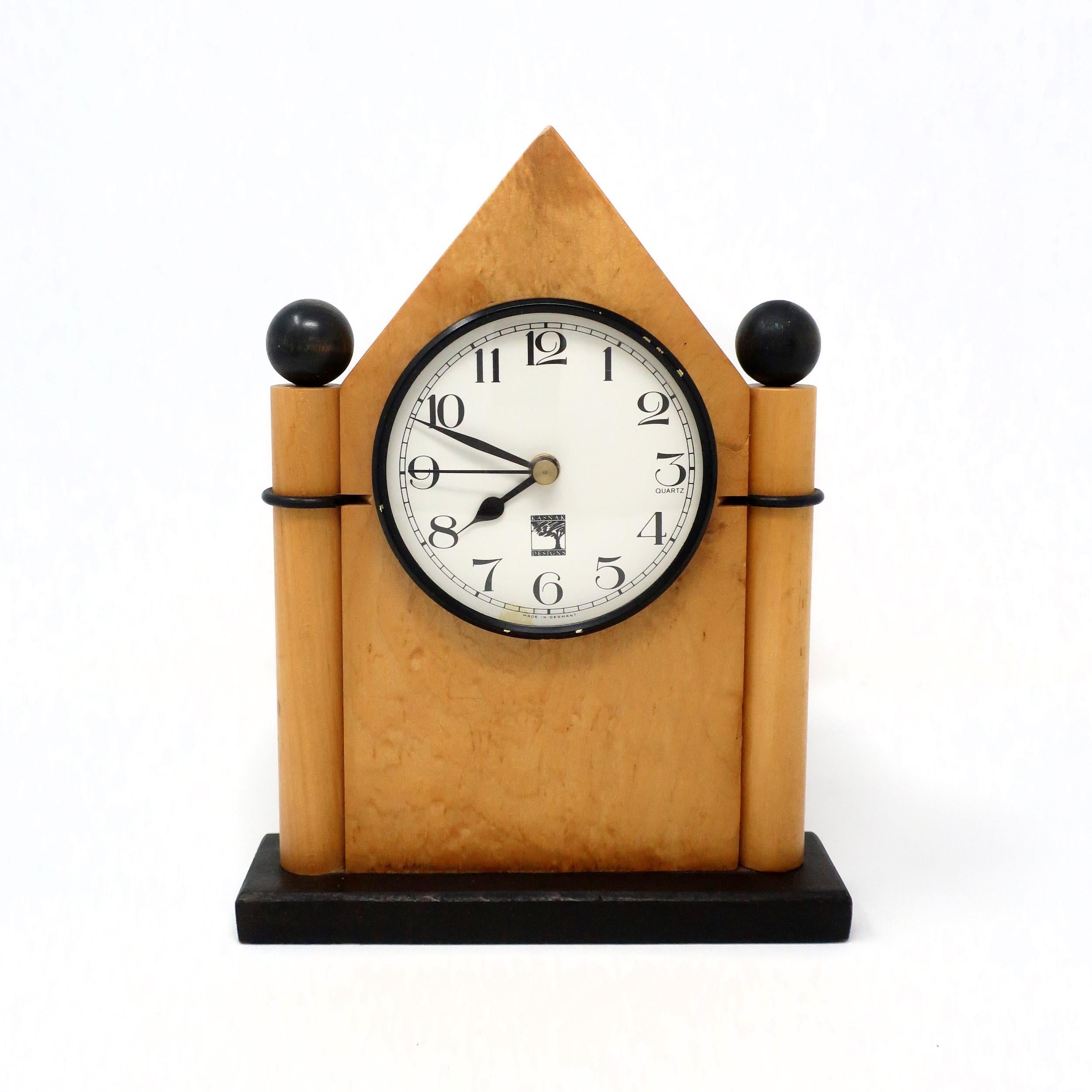 A gorgeously handcrafted wood mantel or desk clock made by in 1990 by Kasnak Designs of Indianapolis, Indiana. A perfect mix of 1980's Memphis Milano-inspired design and Mission/Art & Crafts expert woodworking. Dark stained wood base with black