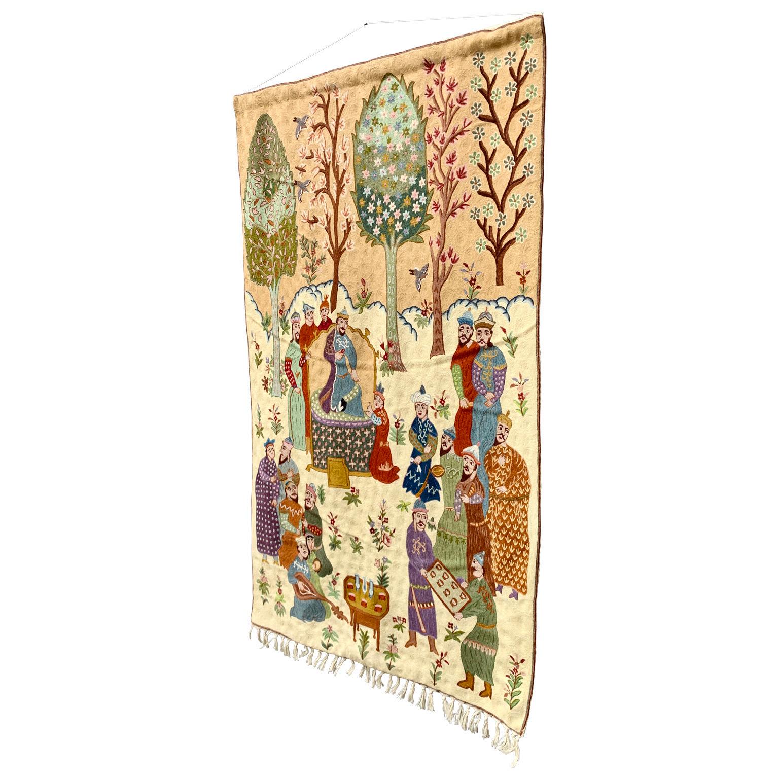 A Mid-Century Modern Semi-Antique handmade Indian (Kashmir region) rug dating around 1960. This embroidered art work representing scenes of a feast among royalties and noble people, was imported by the notorious Swedish design home NK in Stockholm,