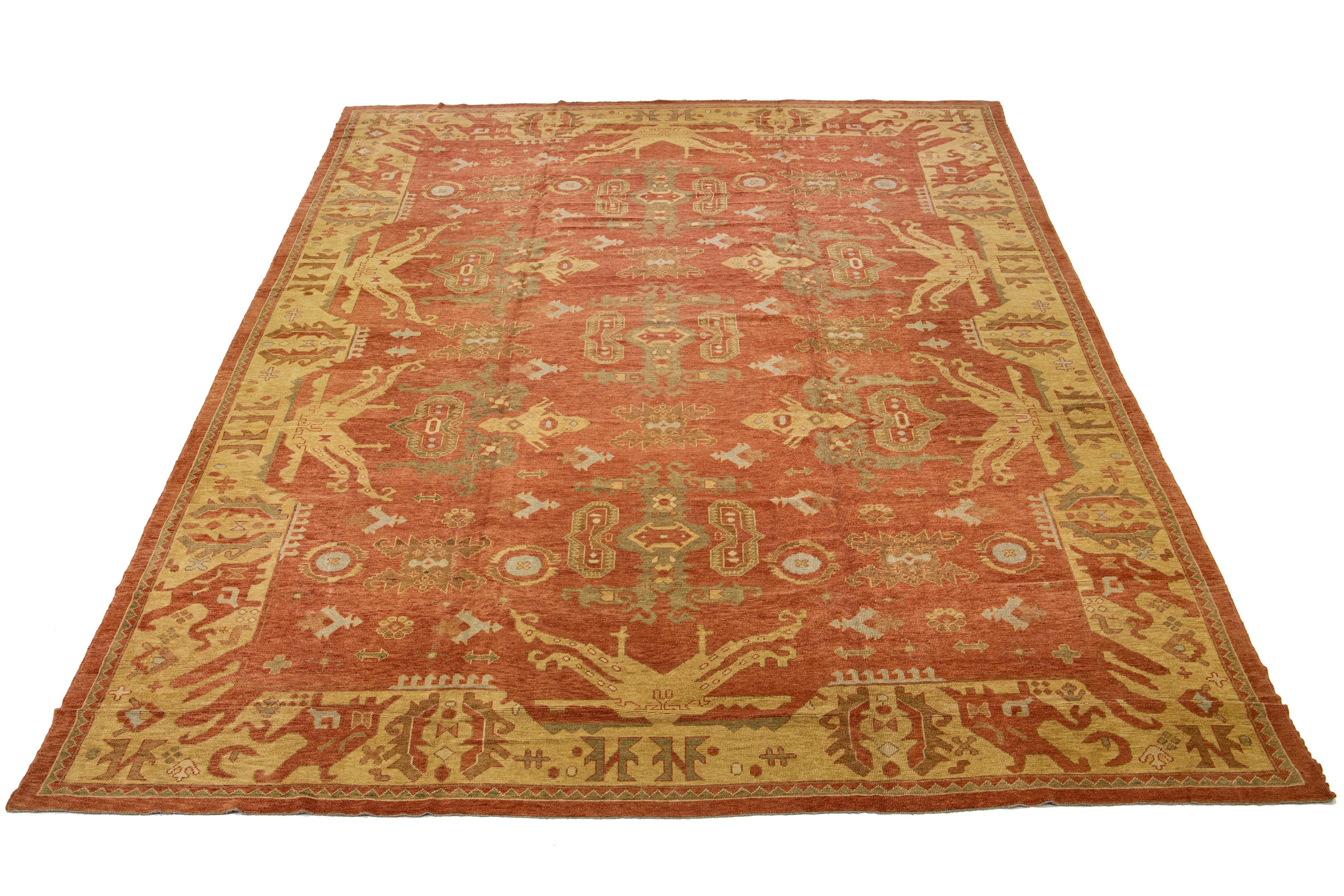 Featuring intricate hand-knotting, this Turkish wool rug boasts an eye-catching deep orange-copper color field framed by a subtle tan hue, with floral geometry in shades of green and blue for a stunning effect.

This rug measures: 14'10