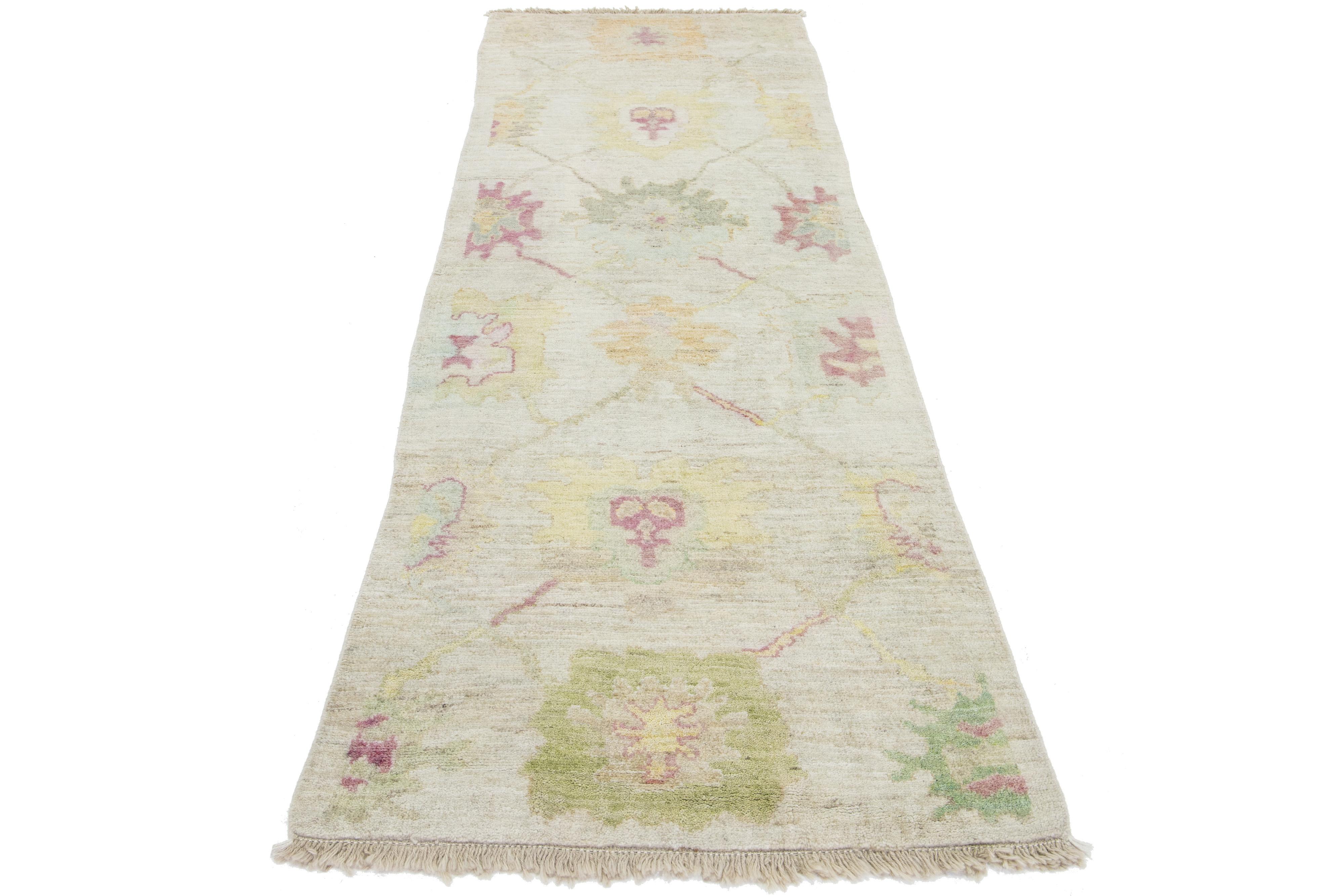 Schöner moderner Oushak-Teppich aus handgeknüpfter Wolle mit beigem Farbfeld. Dieses türkische Stück hat gelbe, blaue, grüne und rote Akzentfarben in einem wunderschönen floralen All-Over-Design.

Dieser Teppich misst 3' x 9'1