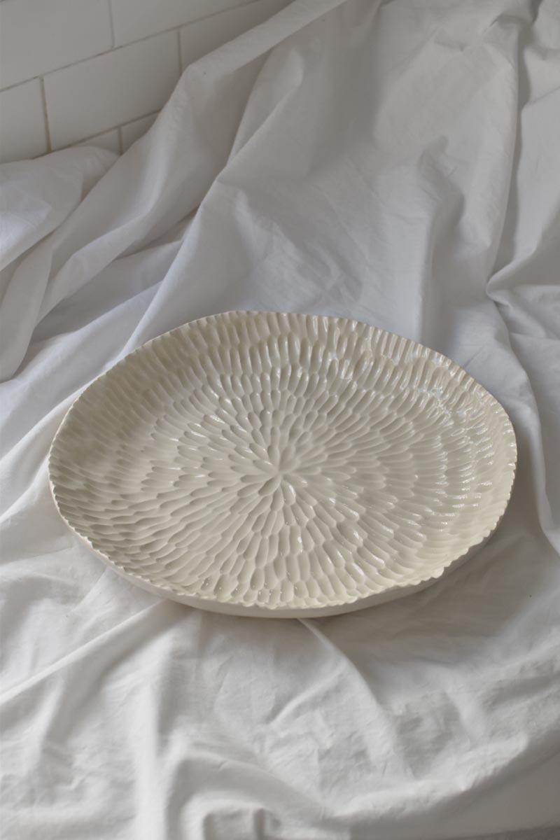 This handmade pottery large serving platter is pure delicacy. With textural details inspired by nature, this carefully hand-carved piece is perfect as a statement for serving dishes, salads, fruits and share foods, or just as beautiful decoration in