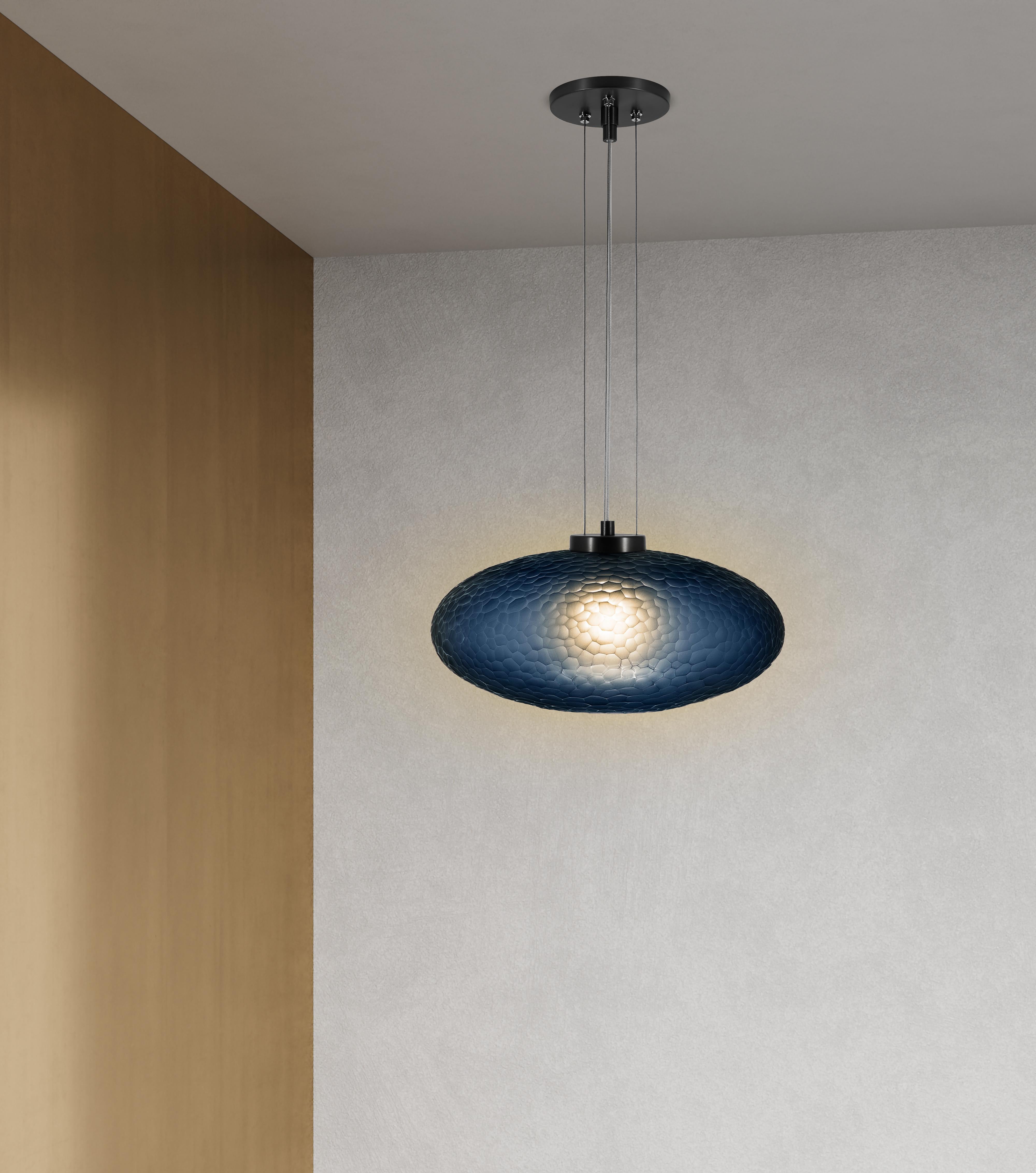 Inspired by the 70s avant-garde aesthetic, the Lennox’s hand-carved Battuto finish lends an elevated ambiance to its retro, oval silhouette. Whether as a pendant or sconce, the special glow of the Lennox glass stands out with a brilliant halo