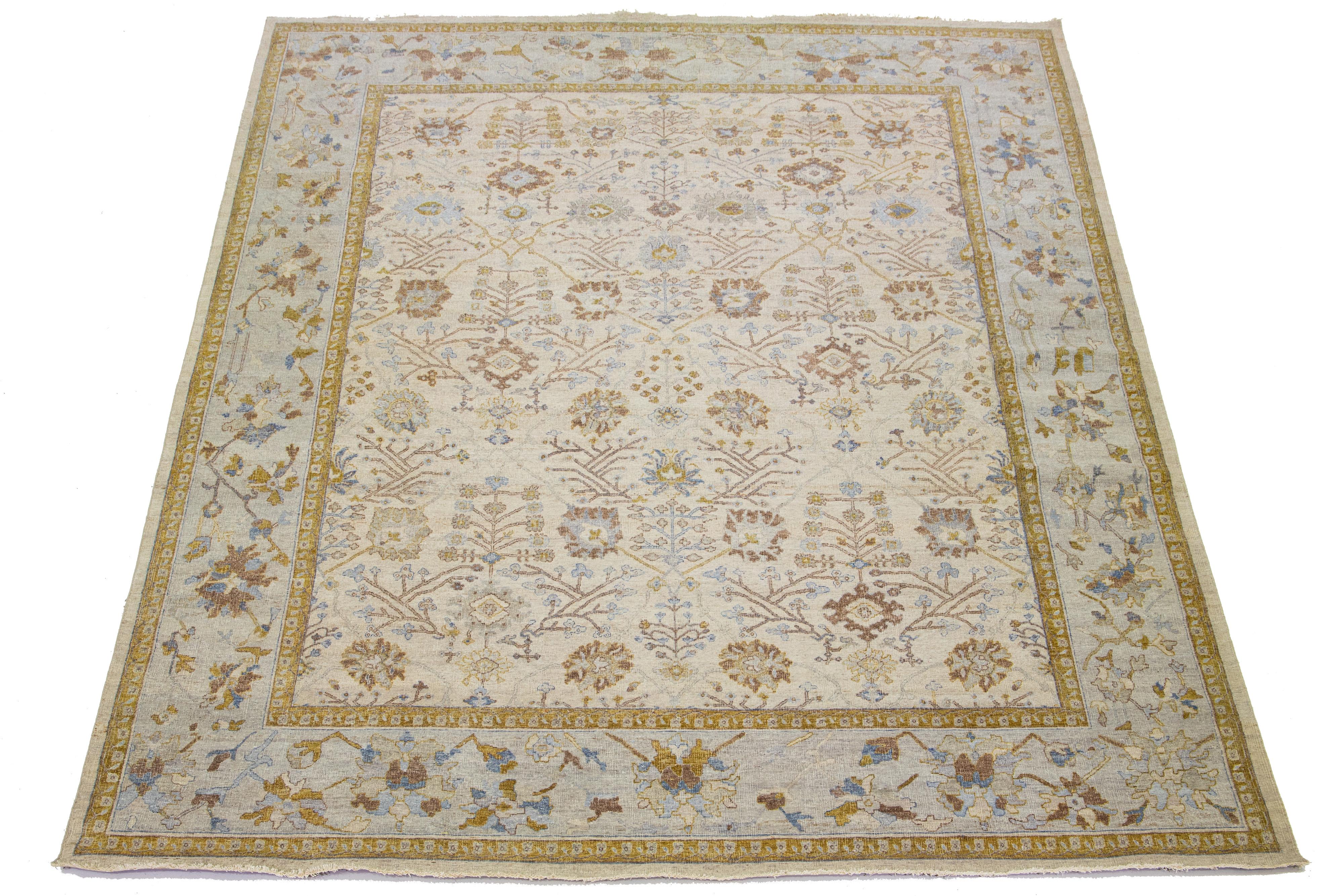 The Artisan line from Apadana brings a beautiful antique style to any space. This hand-knotted rug showcases a charming all-over floral pattern with a beige color scheme and gray, goldenrod, and brown accents. 

This rug measures 11' 11