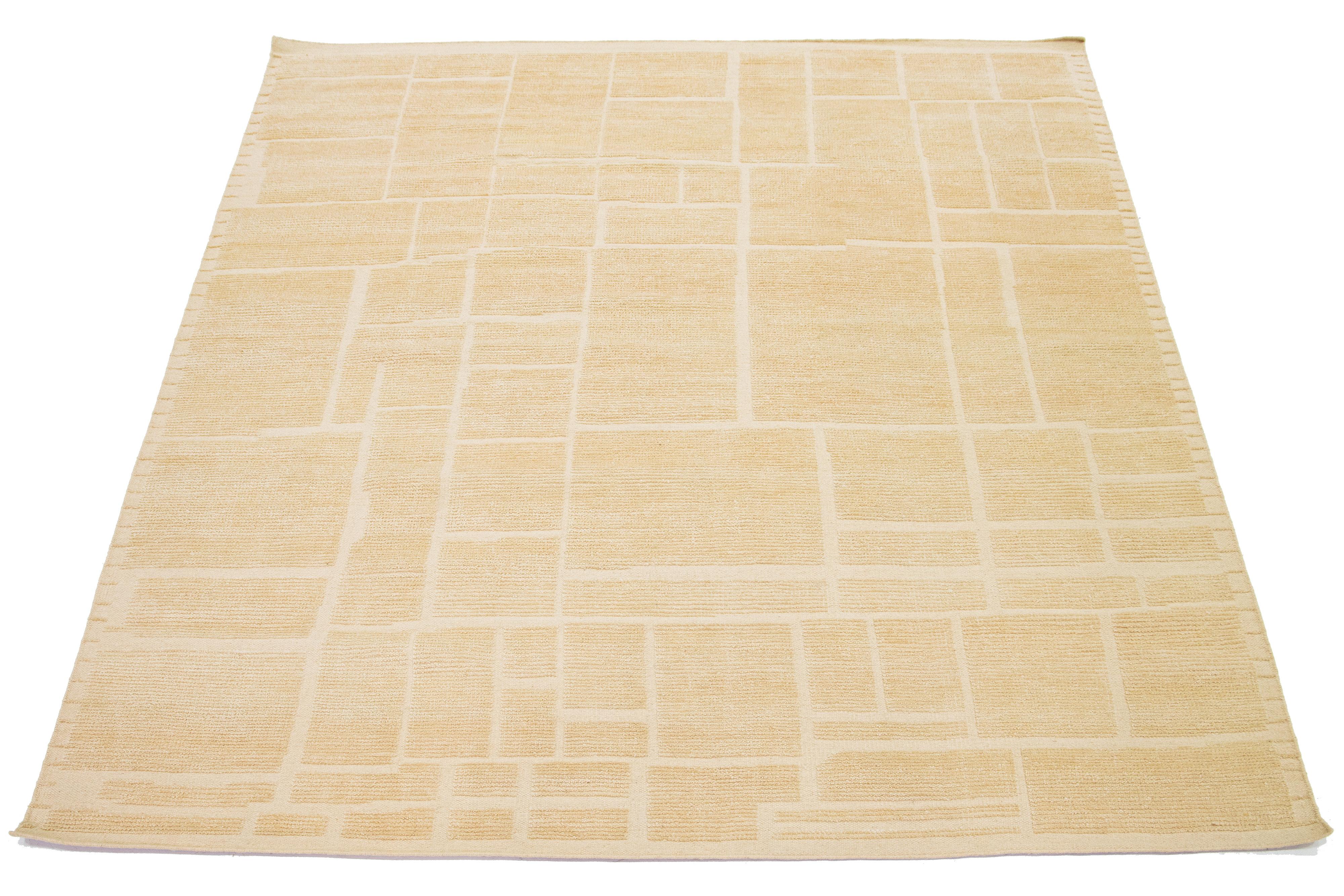This beautiful, modern Moroccan-style rug is hand-knotted using wool and features a natural beige-tan color for the field. It showcases a stunning geometric design.

This rug measures 8' x 10'.