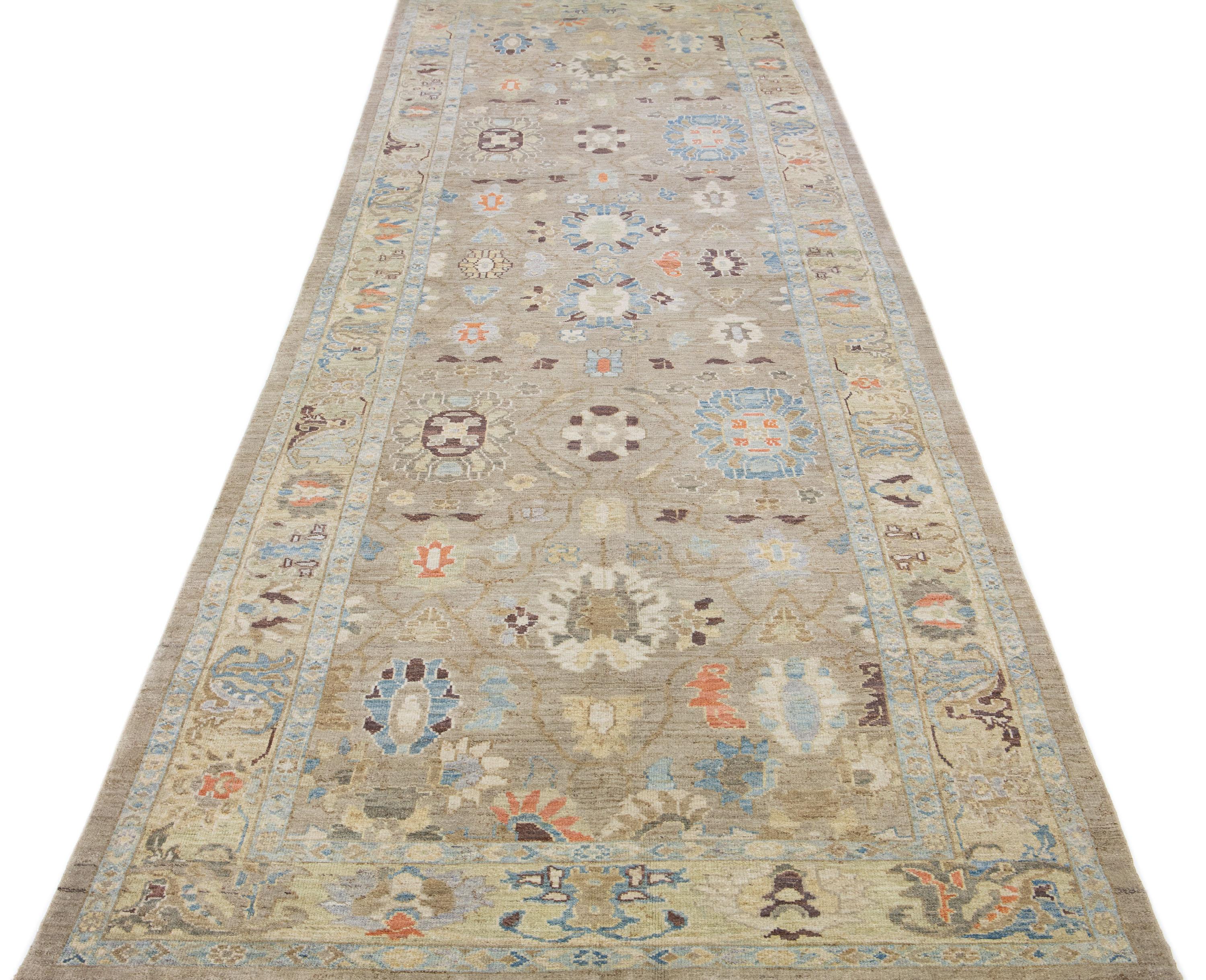 Beautiful modern Sultanabad hand-knotted wool rug with a beige color field. This rug has a designed frame with orange, brown, and blue accents in a gorgeous all-over floral design.

This rug measures: 6' x 19'1