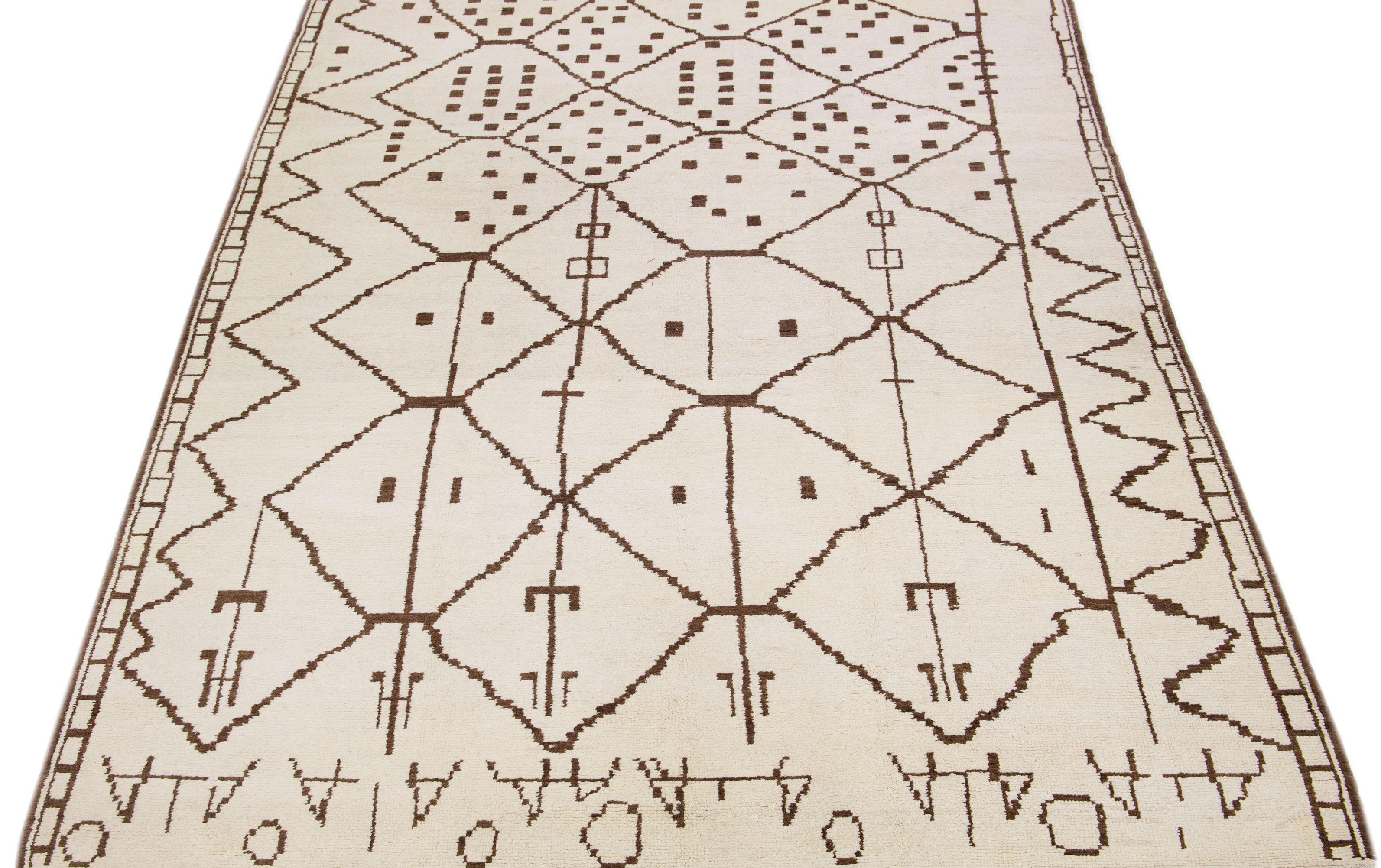 Our Moroccan hand-knotted wool rug showcases an ivory field adorned with a contemporary tribal motif, producing an alluring Moroccan design.

This rug measures 8'9