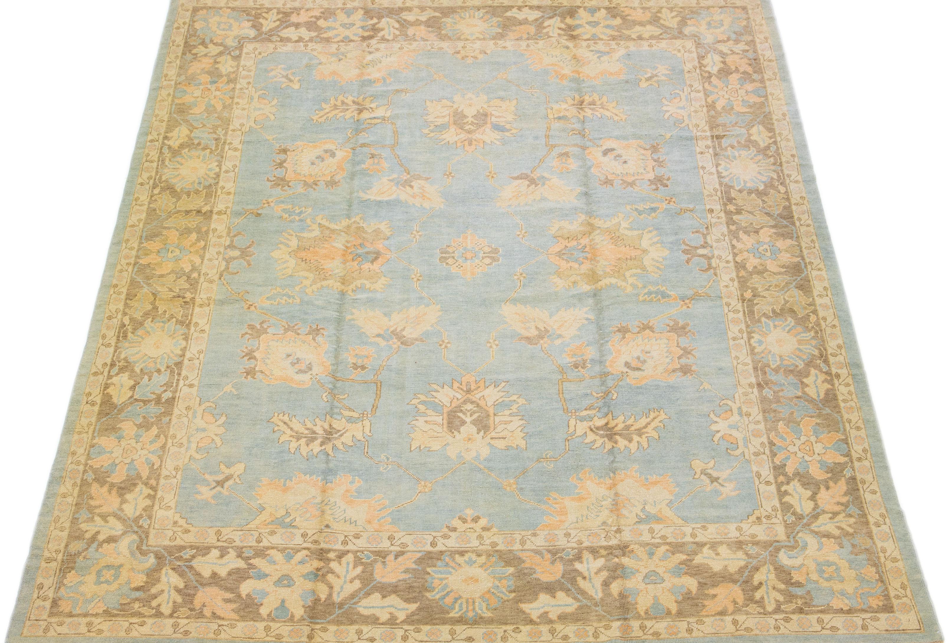 This modern Turkish wool rug boasts a light blue field, beautifully framed with brown, peach, and beige highlights in an intricate all-over floral pattern.

This rug measures 11'7