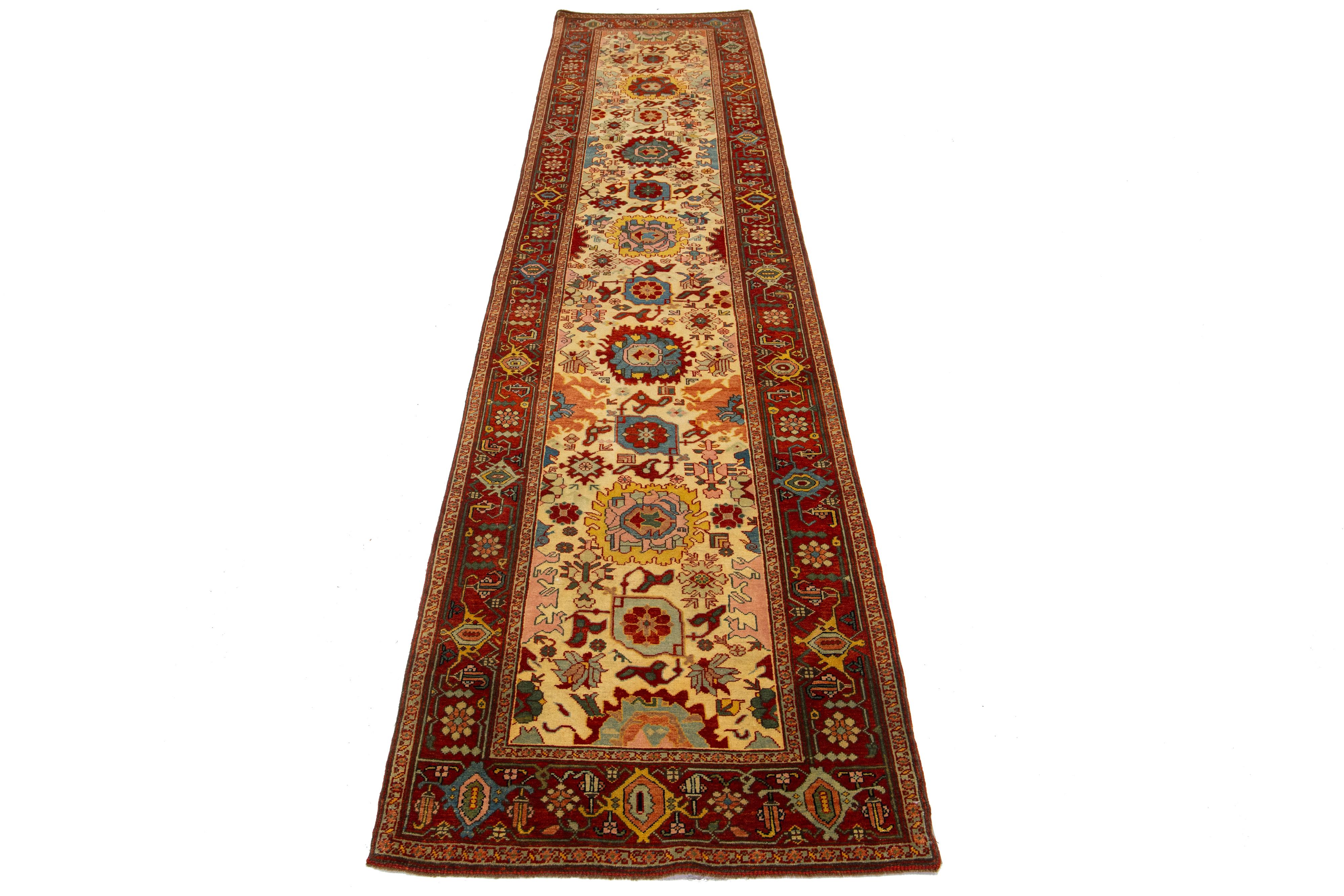 This beautiful modern Oushak hand-knotted wool rug features a beige color field. It is a Turkish piece with a red frame and stunning accent colors of blue, yellow, green, and pink, all woven into a gorgeous all-over floral design.

This rug measures