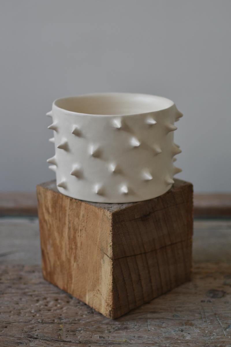 Beautiful ceramic handmade plant pot. Carefully crafted, each planter is thrown and trimmed on the wheel, and every outer spike is individually attached by hand. Finished with a hand-applied matte hazelnut glaze.

As a result, each handmade ceramic