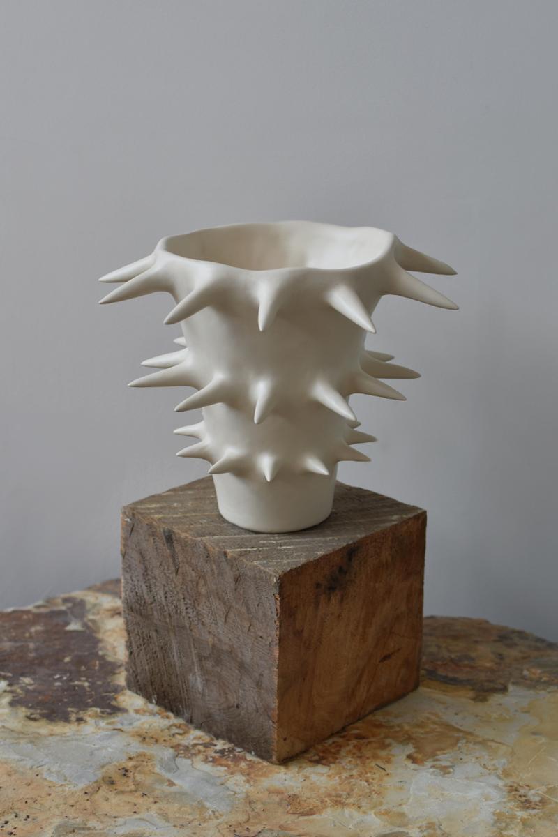 Beautiful white ceramic flower vase with spikes, perfect for showcasing your cherished blooms. Providing a unique perspective from every angle, this handmade ceramic vase blurs the line between functionality and ornament. Use it either as a fully