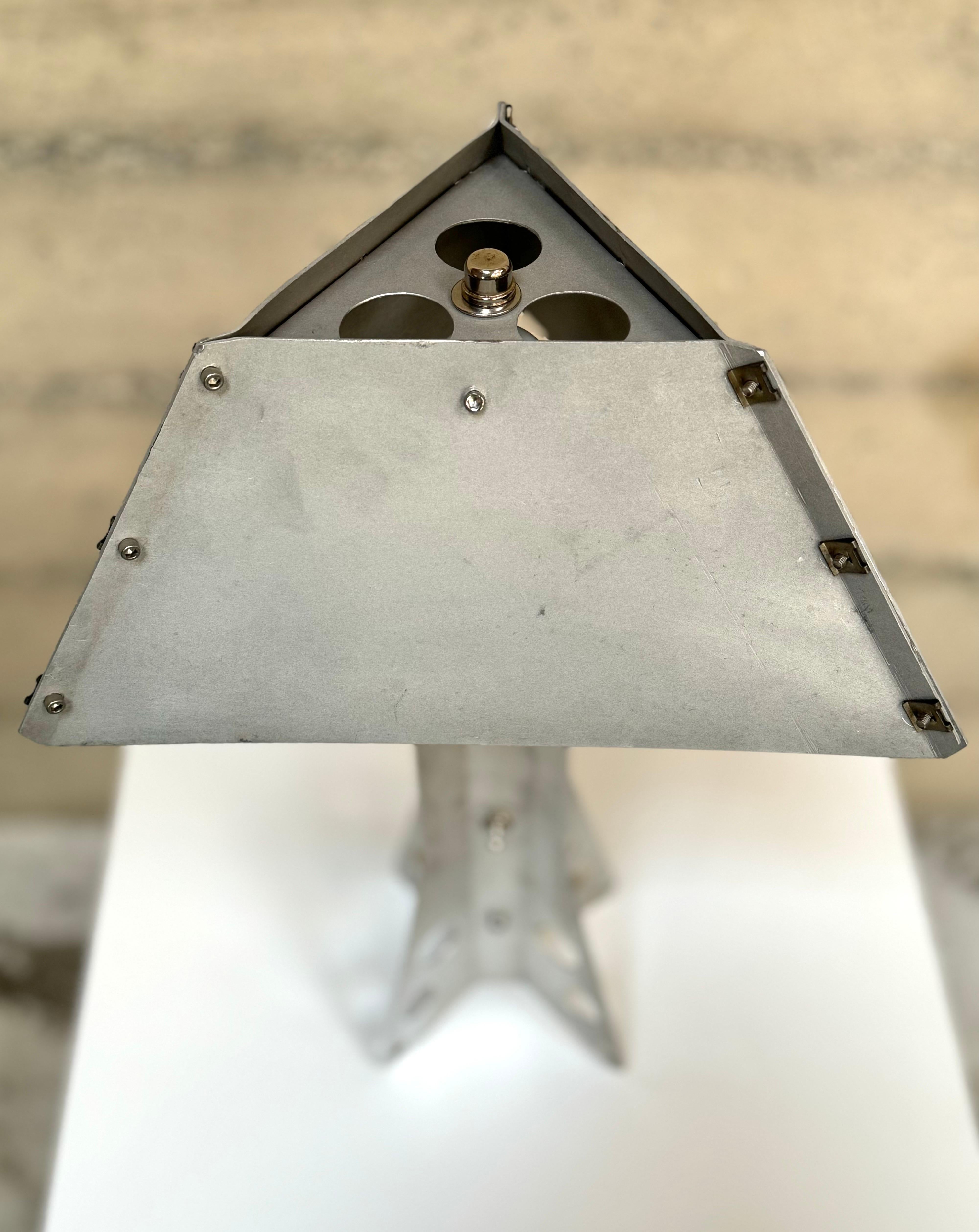 One of a kind table lamp constructed of aluminum, stainless steel and aircraft fasteners. Handmade of aluminum that has been cut and folded to create the shade and base, the shade is held together  with aircraft fasteners and stainless steel hex