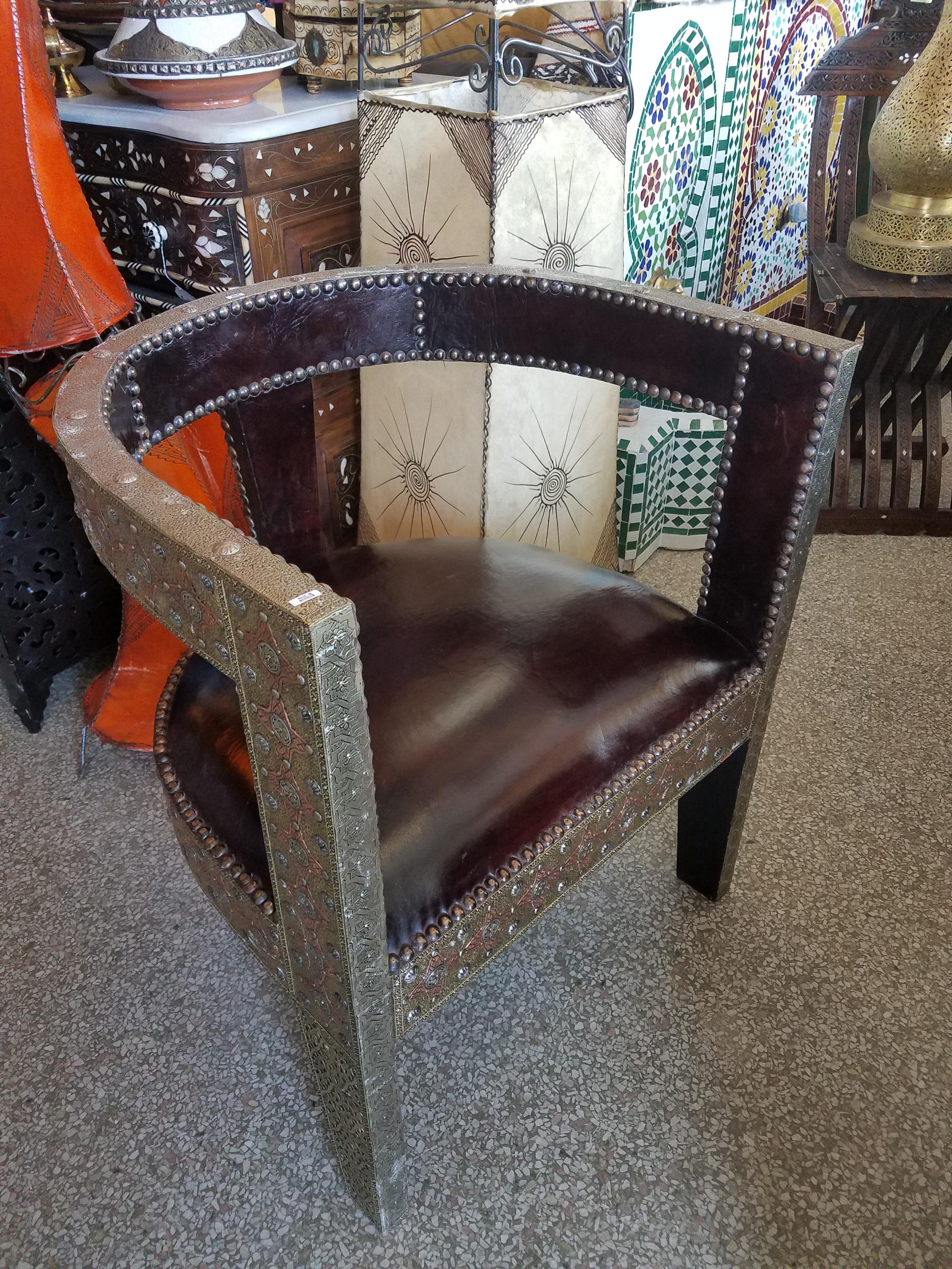 An amazing Cedar wood chair.
Handmade Moroccan wooden chair with genuine leather cushion and metal inlaid frame throughout, measuring approximately 29