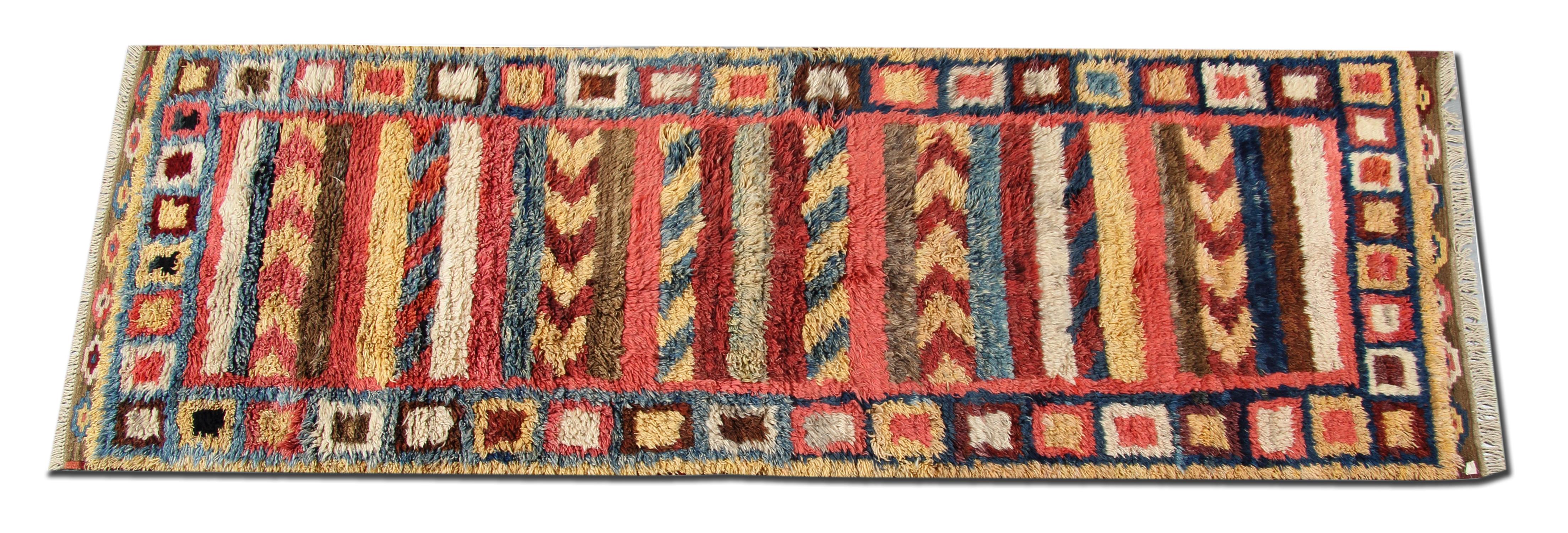 This handmade carpet is an example of handwoven rugs from Morrocco. Featuring designs that are traditional to the Morocco region. Morocco is famous for its primitive traditional rugs with long wool piles. Weavers used top quality hand-spun wool and