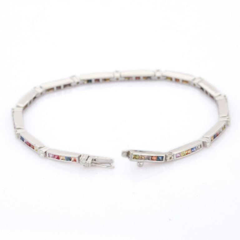 This Classic Multi Sapphire Thin Tennis Bracelet in Sterling Silver showcases endlessly sparkling natural multi sapphire weighing 3.51 carat and diamonds weighing 0.61 carats. It measures 7 inches long in length. 
multi sapphire improves mental